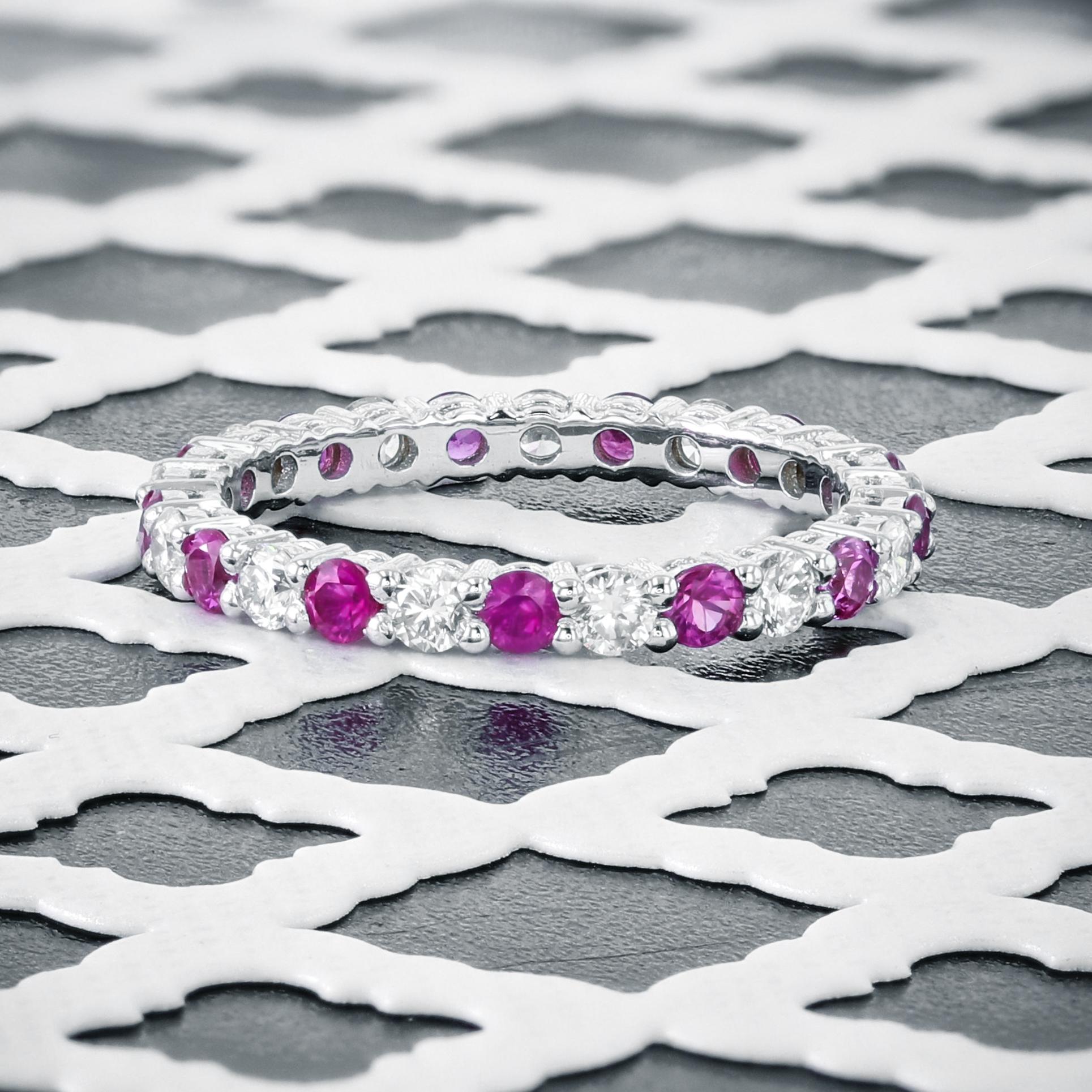 Carefully selected pink sapphires and white diamonds create a delightful and beautiful ring that you will love wearing.  The band features over half a carat of white diamonds (D/E color) and half a carat of deep pink sapphires.  Precise carat weight