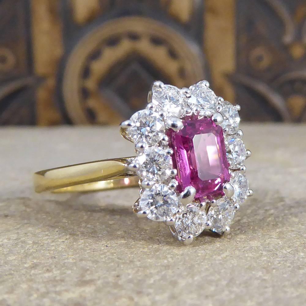 This fabulous new ring features an Emerald Cut Pink Sapphire weighing 1.15ct in a four claw setting. Surrounded by 10 modern brilliant cut Diamonds weighing 1.00ct in total, it sits in a 18ct white Gold claw setting to complement the stones leading