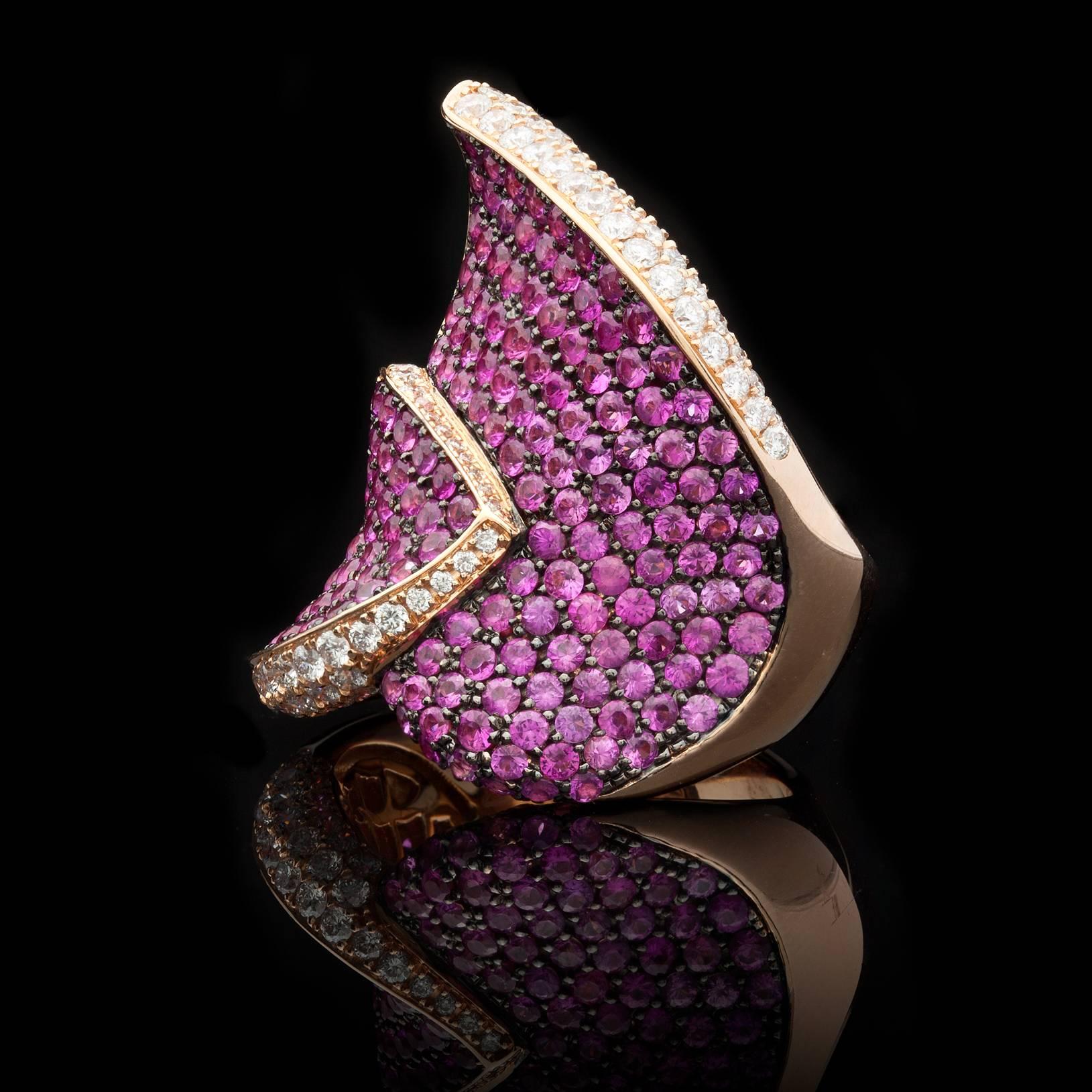 Exceptional Cocktail Ring by Salavetti features 5.31cts of Round Brilliant Cut Pink Sapphires accented by 110 Round Brilliant Cut Diamonds for approximately 1.27cts. The total weight of the ring is 22.24 grams and the face of the ring measures 24mm