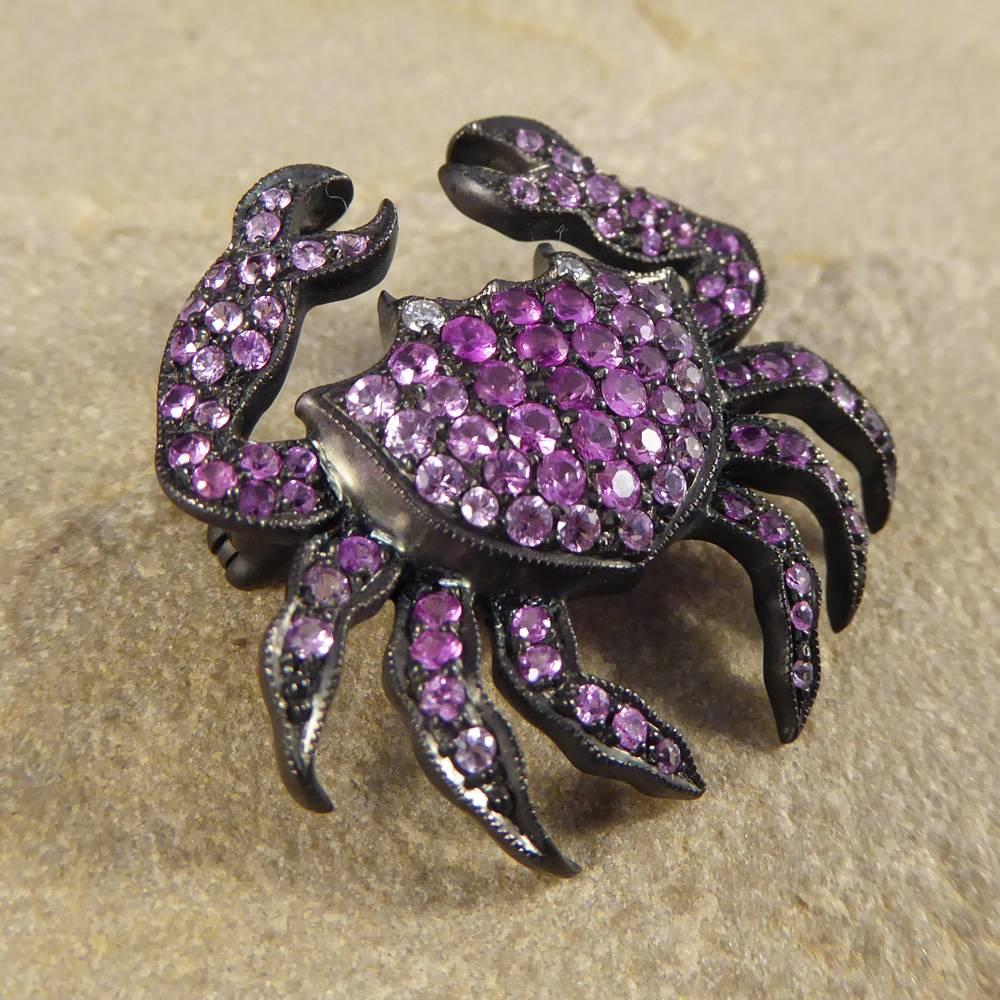 This Contemporary Crab Brooch can also be worn as a Pendant by hanging the chain through the claws as it sits delicately on the chest bone. Crafted from oxidised 18ct Gold and set with beautiful different shades of Pink Sapphires and Diamond set