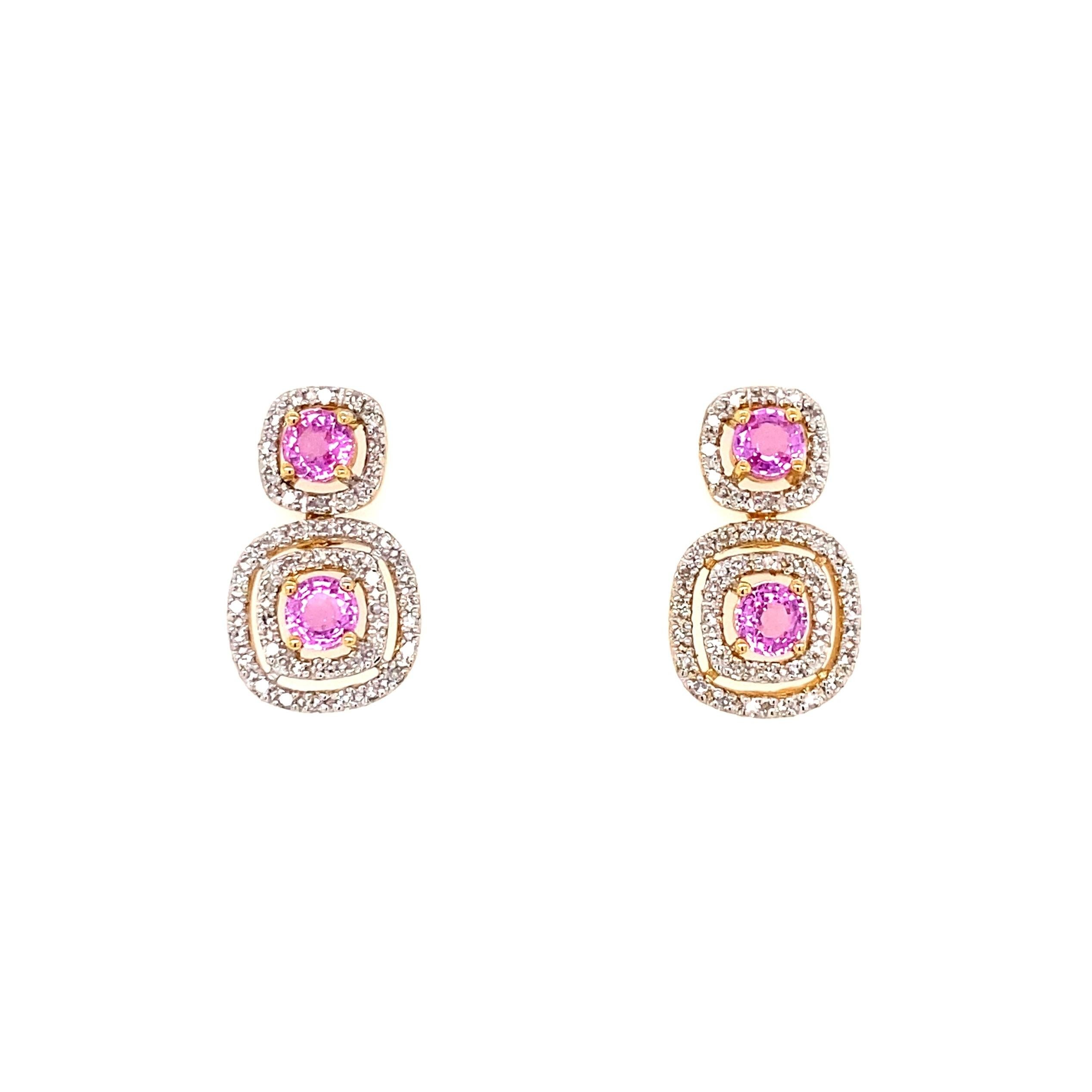 Simply Beautiful! Finely detailed Double Drop Gold Halo Earrings. Each Earring centering a securely Hand set Pink Sapphire, weighing approx. 1.15tcw. Surrounded with Diamonds weighing approx. 0.35tcw. Measuring approx. 0.76