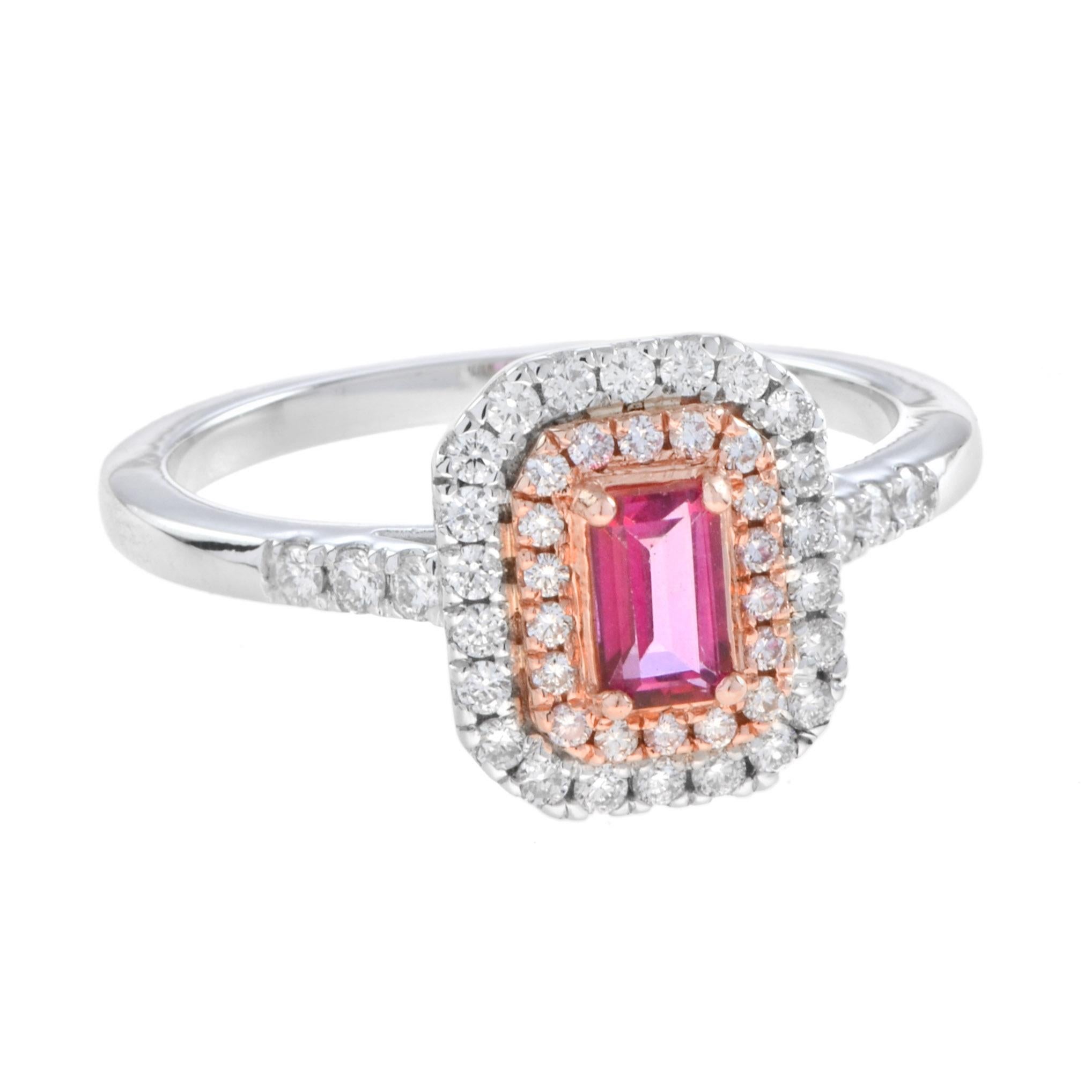 The two-tone version of standout double halo engagement ring is designed to hold 0.4 carat emerald cut pink sapphire center stone. The outer halo is in white gold while inner halo is rose gold. A truly spectacular engagement ring! Wear it with our