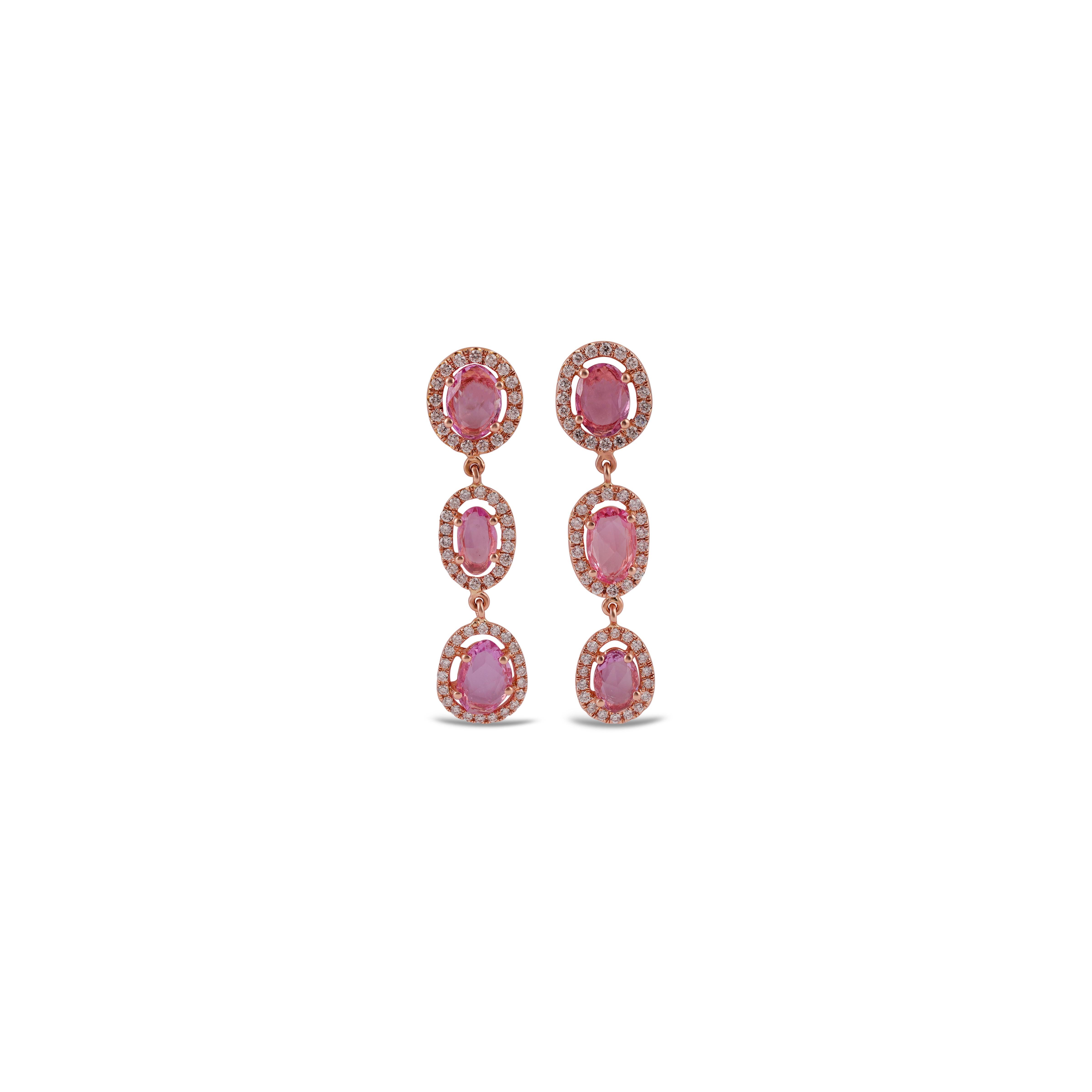 These are an exclusive earrings with Pink sapphire & diamonds features 6 pieces of Sapphire weight 2.86 carats, surrounded with 111 pieces of round brilliant cut of diamonds weight 0.69 carats, These entire earrings are studded in 18k rose Gold.