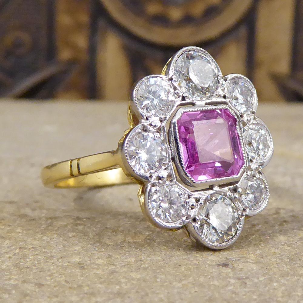Such a beautiful Contemporary ring with a Pink Sapphire in the centre weighing 0.95ct. Accompanying the Pink Sapphire are 8 modern brilliant cut Diamonds circling the Sapphire weighing a total of 1.25ct with the Diamonds on the top and bottom being