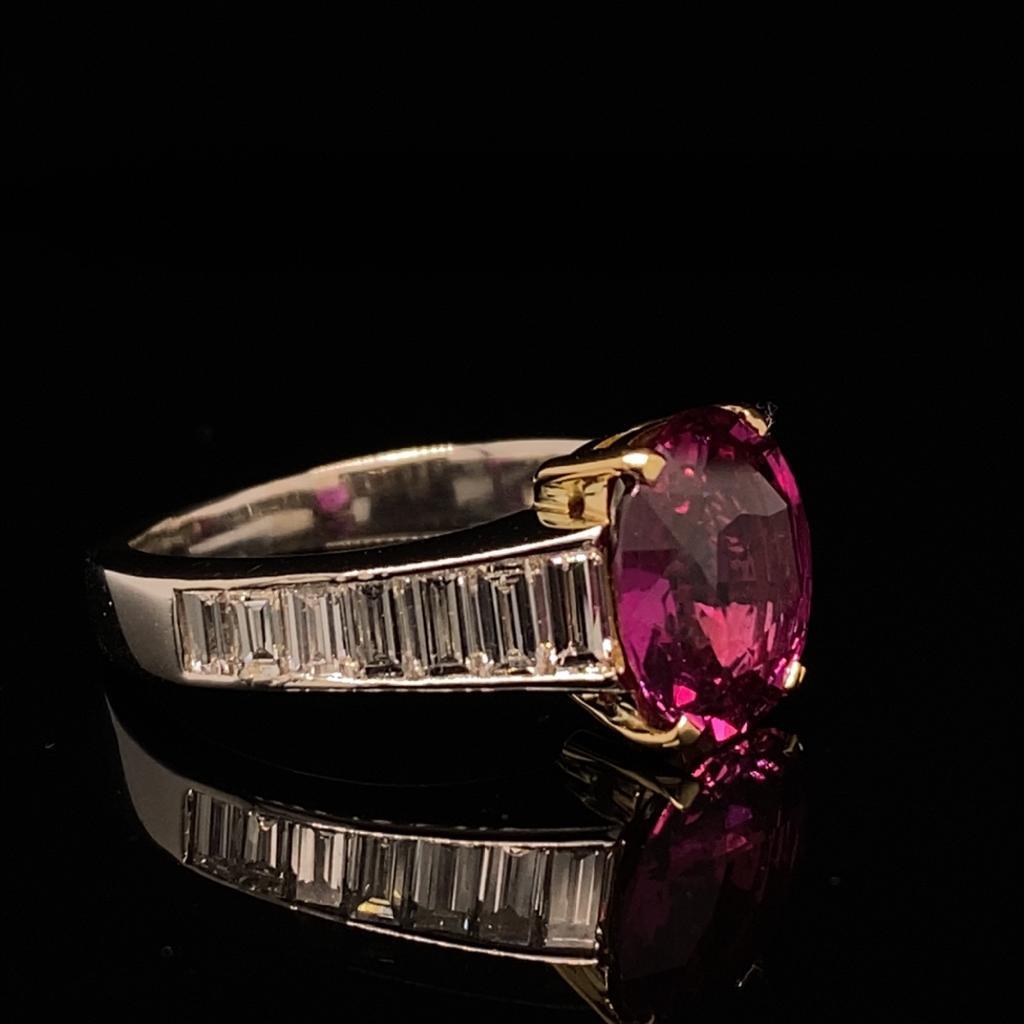 A pink sapphire and diamond engagement ring in platinum and 18 karat yellow gold.

This ring is centrally set with an beautiful 3.15 carat oval brilliant cut pink sapphire which is claw set in 18 karat yellow gold to enhance its deep intense fuchsia