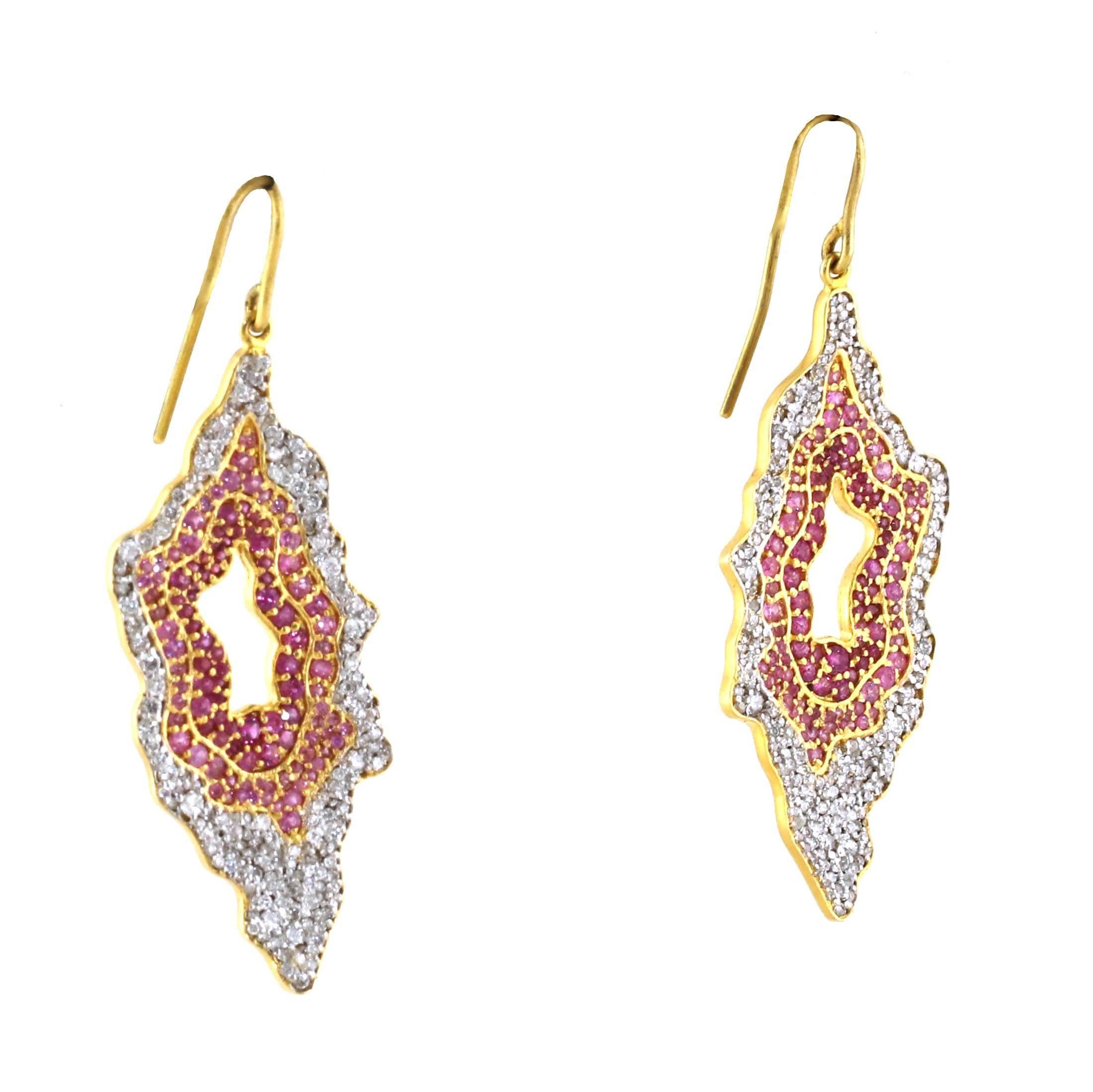 Rare and unique pair of pink sapphire and white diamond geode shaped earrings. Over 1.40 carats of white diamonds set among bright pink sapphires. These are made in 18kt yellow gold making them much finer than a pair of 14kt gold earrings. 

