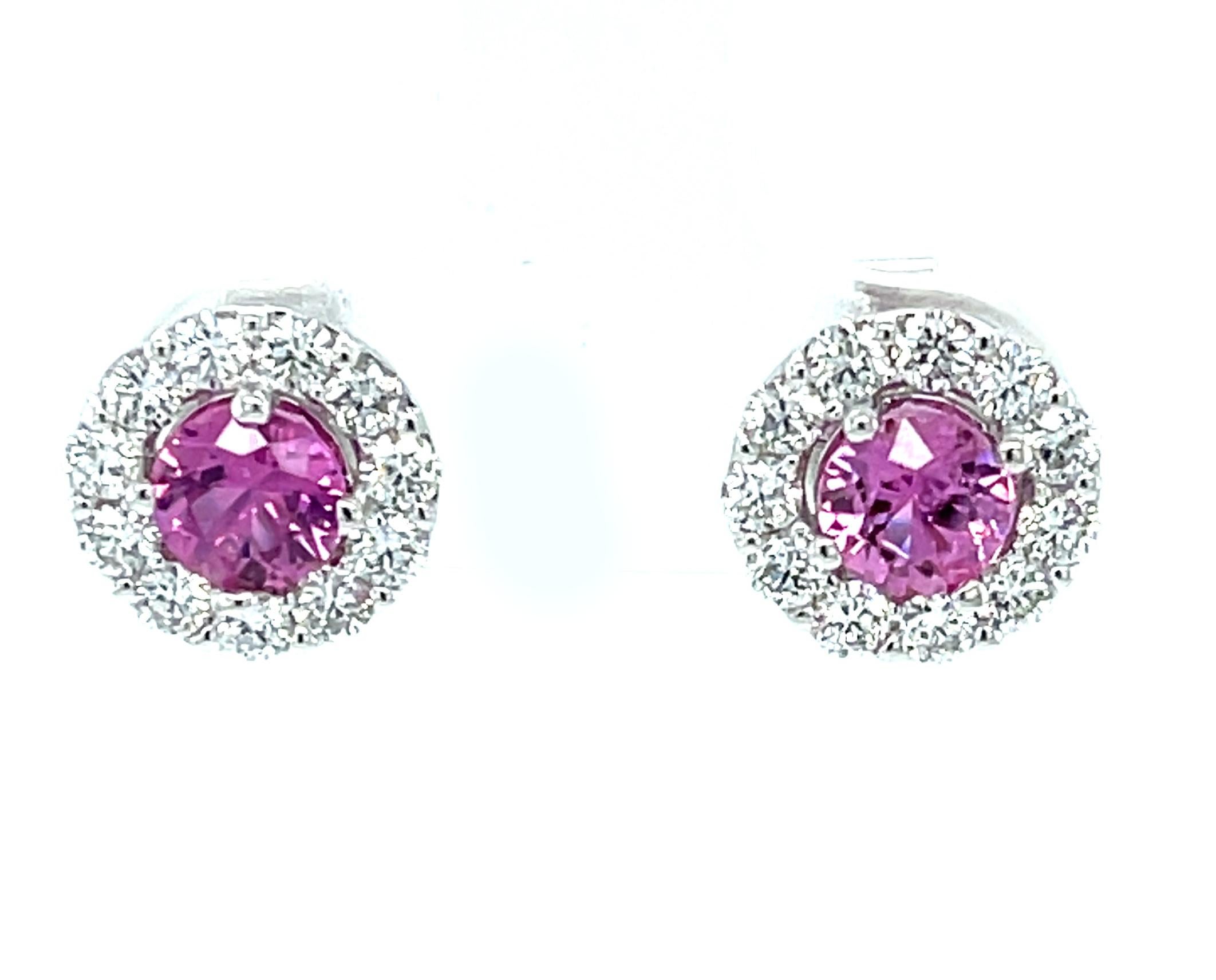 These gorgeous pink sapphire earrings feature a beautifully matched pair of vibrant pink sapphires framed by a sparkling halo of brilliant white diamonds! Set in 18k white gold, these stud earrings are the perfect complement for any outfit, day or
