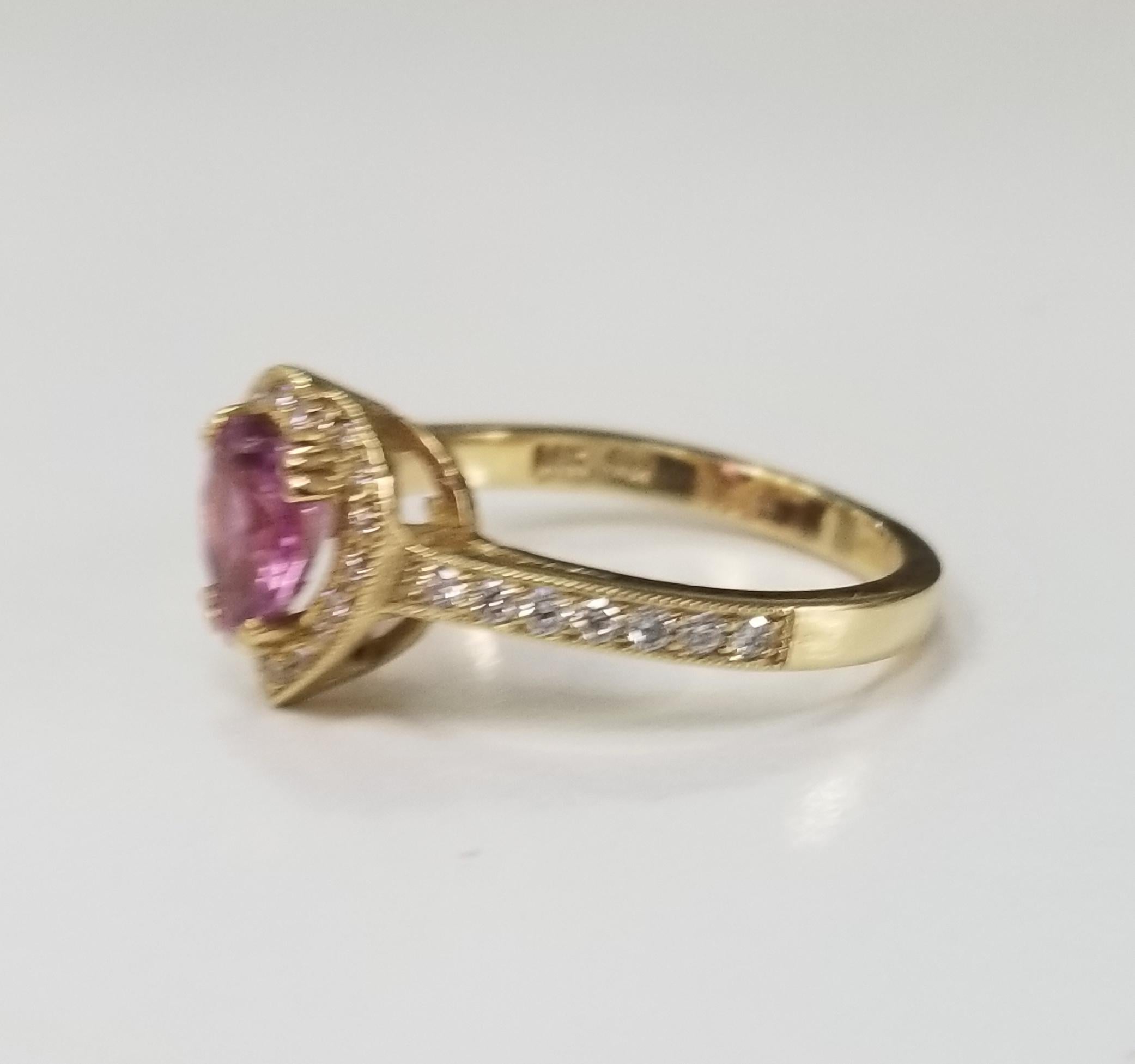 14k yellow gold pink sapphire and diamond ring, containing 1 heart shape cut pink sapphire of gem quality weighing 1.40cts. and 33 round full cut diamonds of very fine quality weighing .25pts.  This ring is a size 7 but we will size to fit for free.