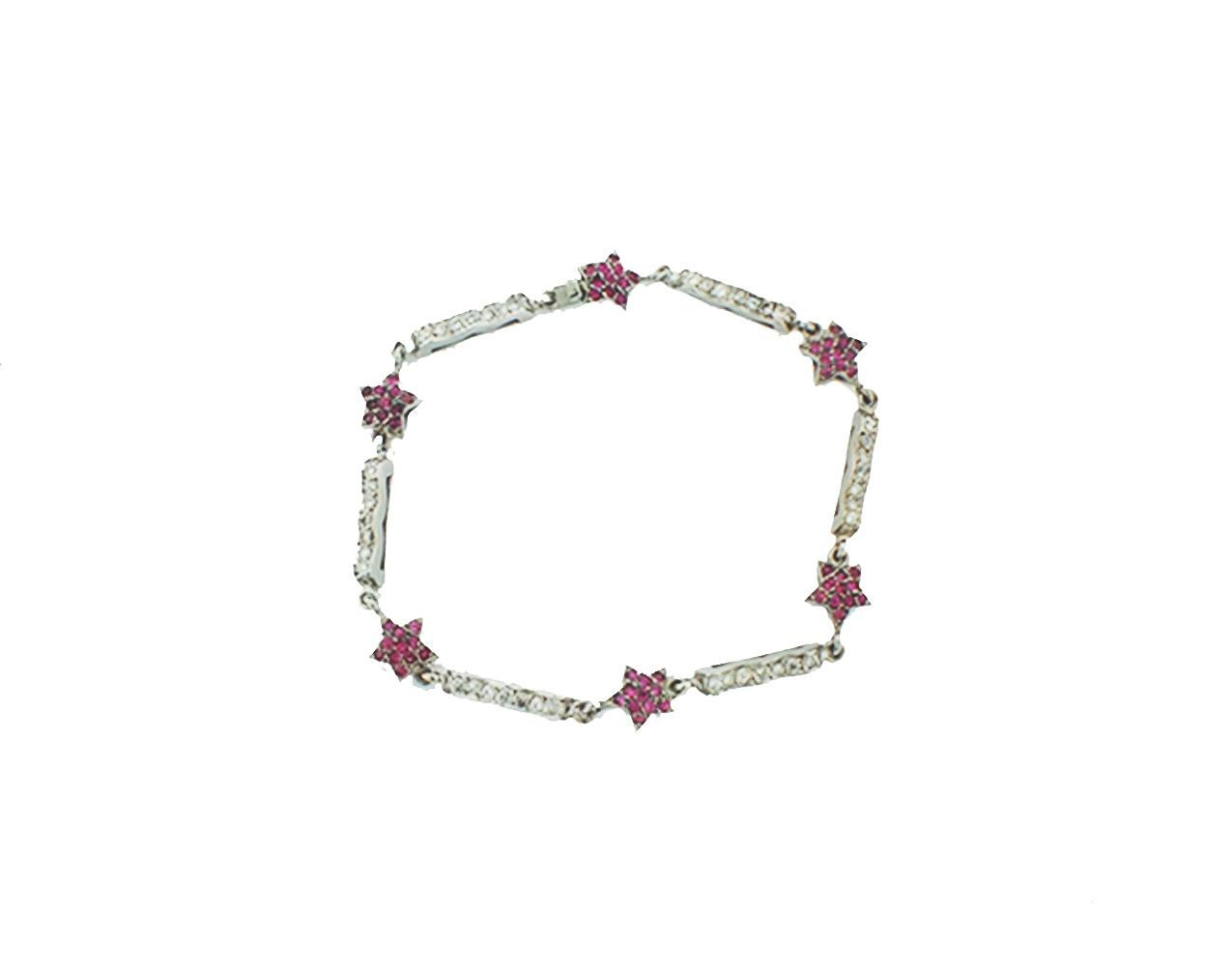 14 karat white gold pink sapphires and diamond tennis bracelet set in shapes of stars bedazzle your wardrobe. The star shaped sapphire links are alternating with links of diamonds set in 14 karat white gold

 The length of the bracelet is 7 inches