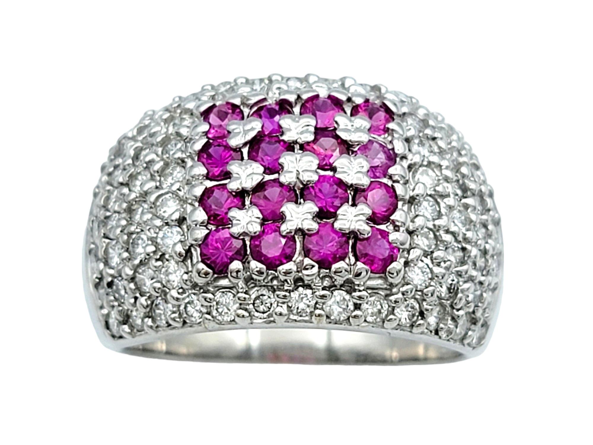 Ring Size: 8

This stunning band ring features a captivating blend of pink sapphires and diamonds, set in luxurious 14 karat white gold. At the center of the ring, a square formation of round pink sapphires creates a bold and eye-catching focal