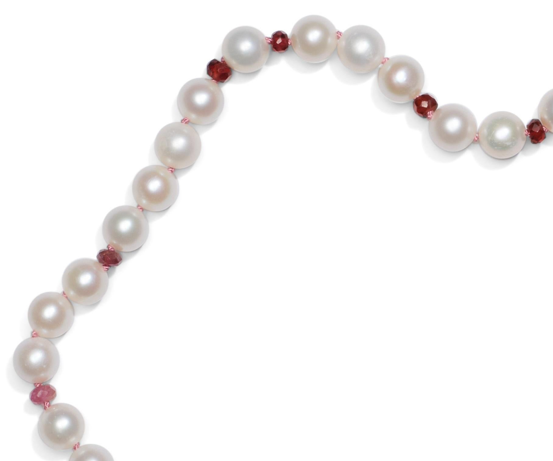 The classic white pearl necklace with 6mm pearls, sparkling pink tourmalines and sapphires! Colors vary from a blush -to a deep saturated pink, hand knotted on pink silk thread, finished with an 14k solid gold clasp.

• White freshwater pearls 
•