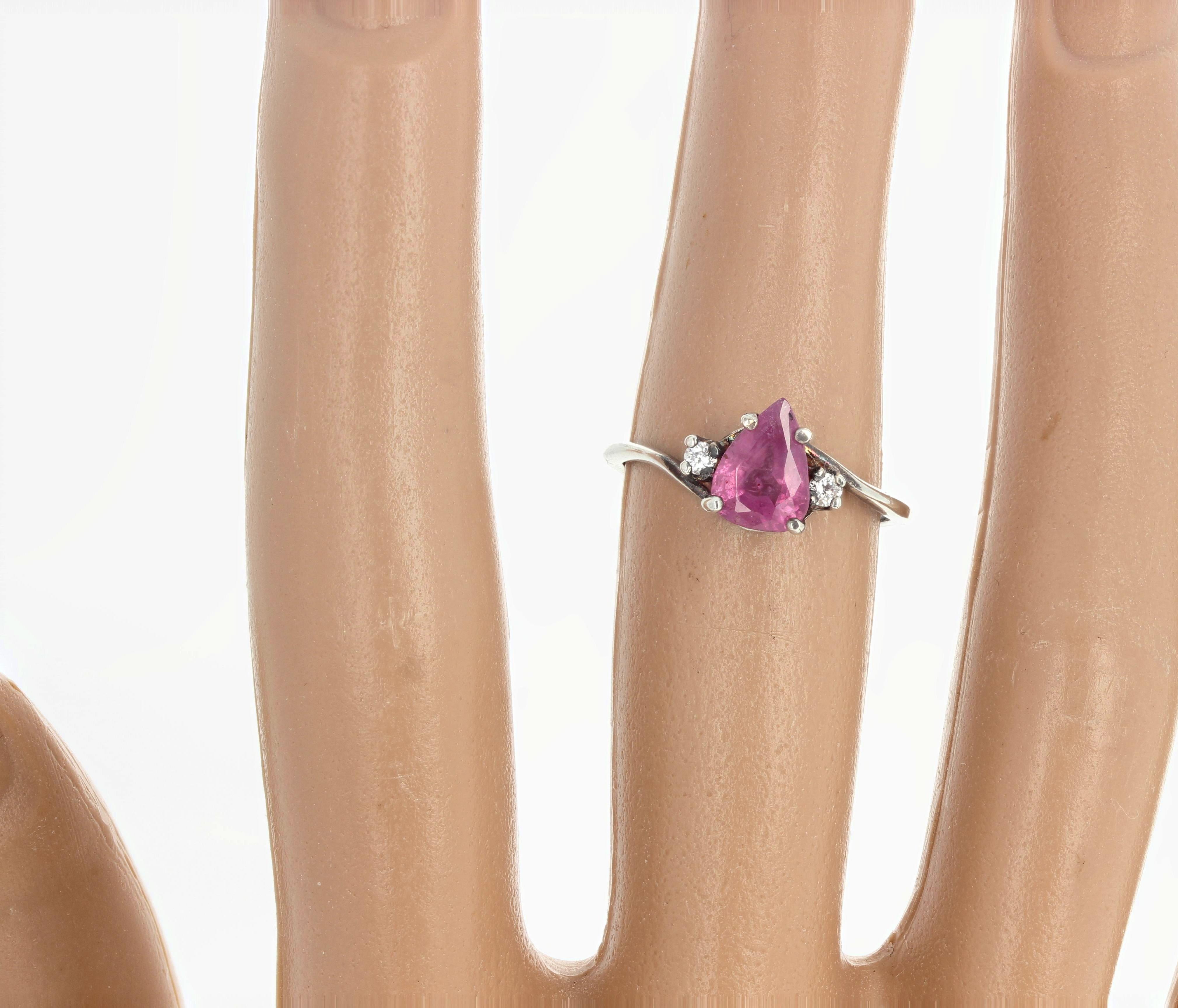Fascinating pinky glowing tear drop natural shaped Sapphire - 1.87 carats - 8.3 mm x 6 mm - enhanced with tiny brilliant sparkling little white natural Zircons set in this wonderful sterling silver ring size 7 sizable.  This sparkles beautifully