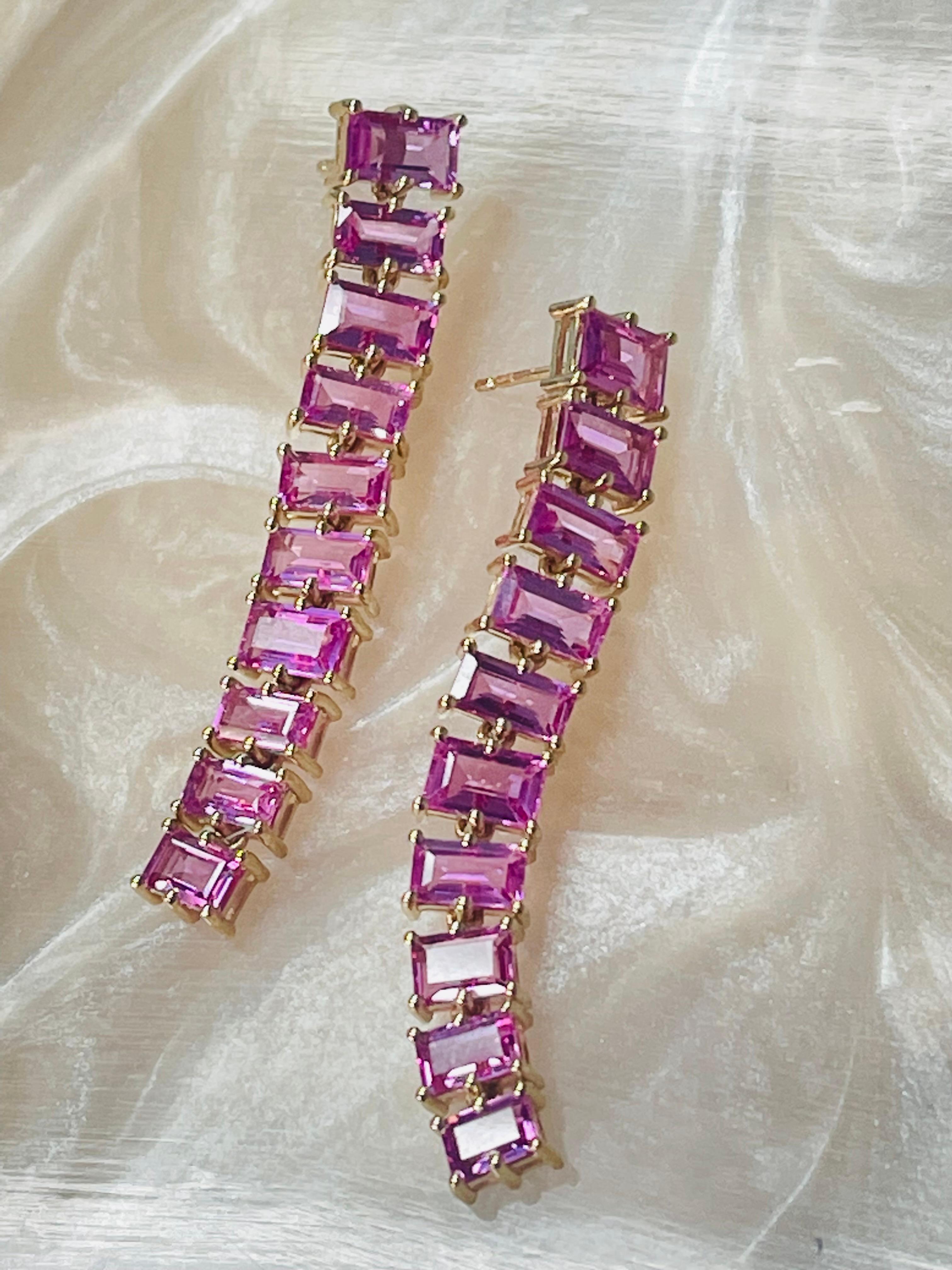Pink sapphire baguette long earrings hand crafted in yellow gold. 
Pink sapphire weight : 14.25 carats / 20 stones 
Metal : 14k yellow gold 
Measurements : 2 1/4 inches 

