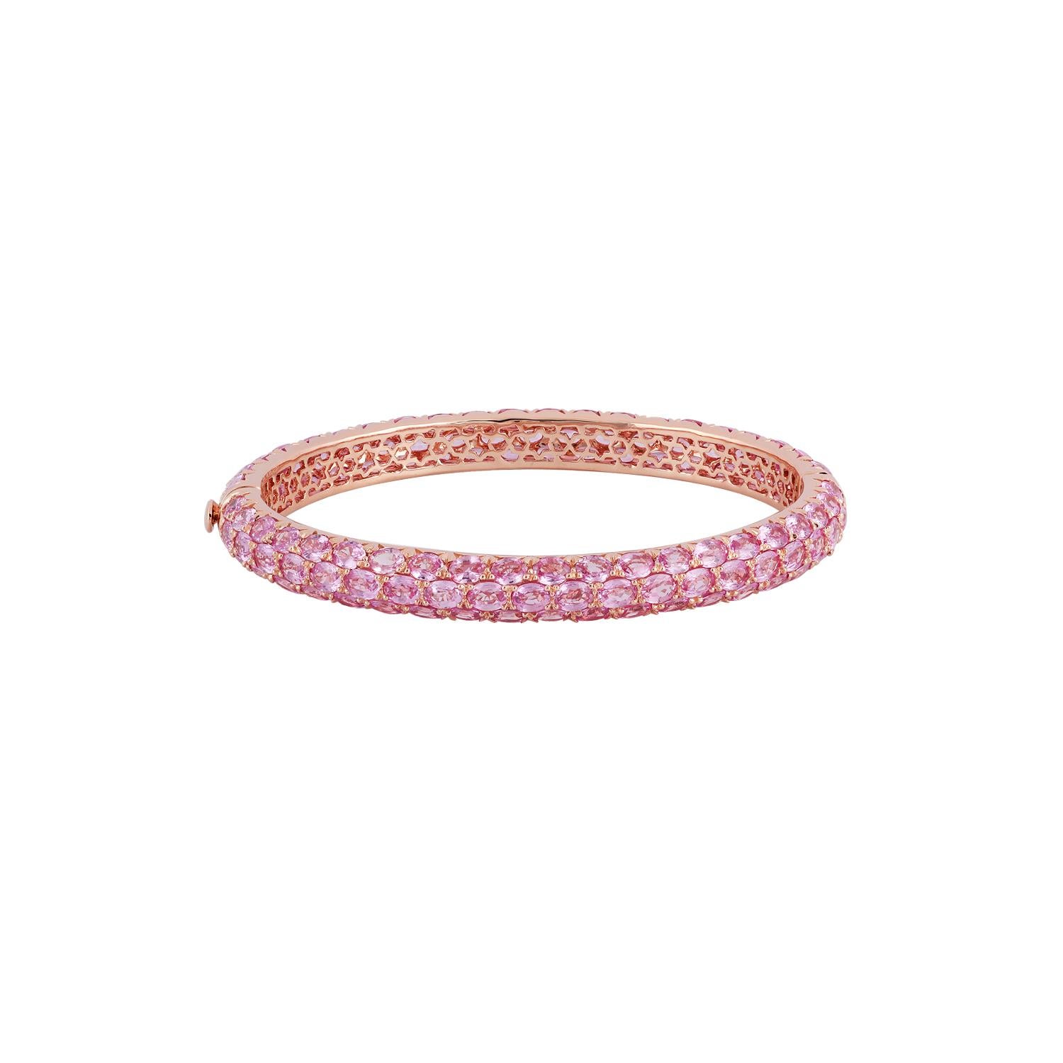 This is an exclusive bangle studded in 18K rose gold, features 124 pieces of oval-shaped pink sapphires weight 22.87 carats & 18K rose gold weight 21.65 grams. This is an elegant bangle to wear.