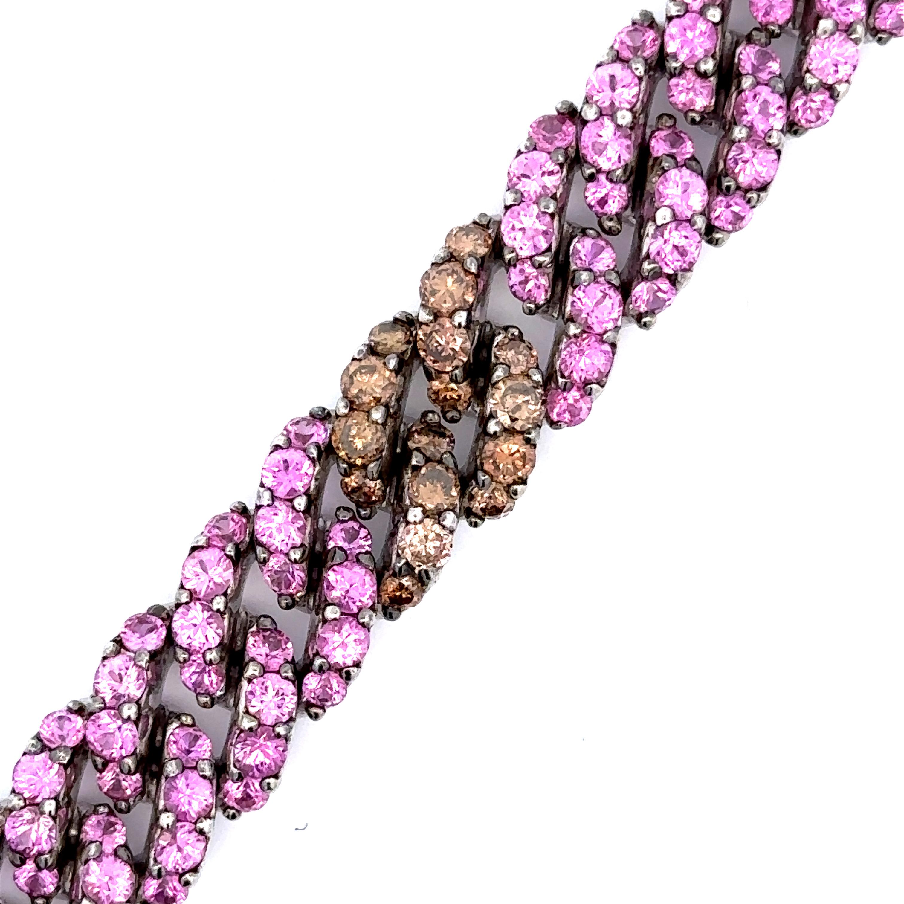 An impressive Curb Link Bracelet set with natural pink sapphires and natural brown diamonds in 18kt white gold.

160 natural pink sapphires weighing 14.90ct total weight

64 natural brown diamond weighing 4.64ct total weight

18kt white gold, 49.7