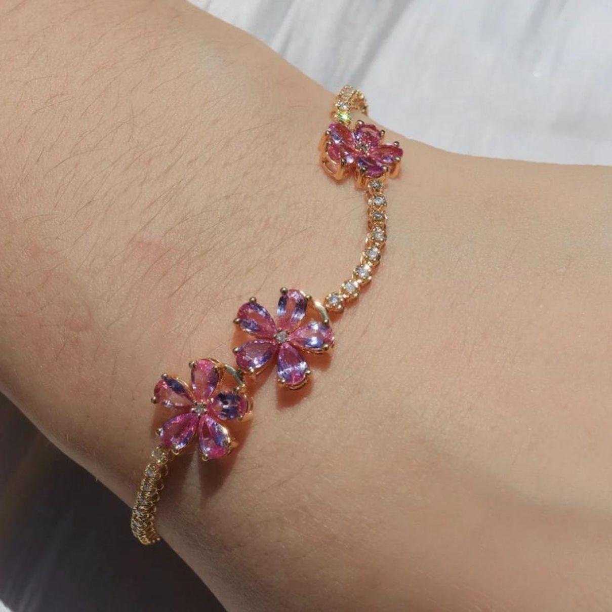 The bracelet showcases meticulously arranged pink sapphires, each one reflecting a soft and enchanting hue that symbolizes love and compassion. The brilliant diamonds add a luxurious sparkle, enhancing the overall allure and sophistication of the