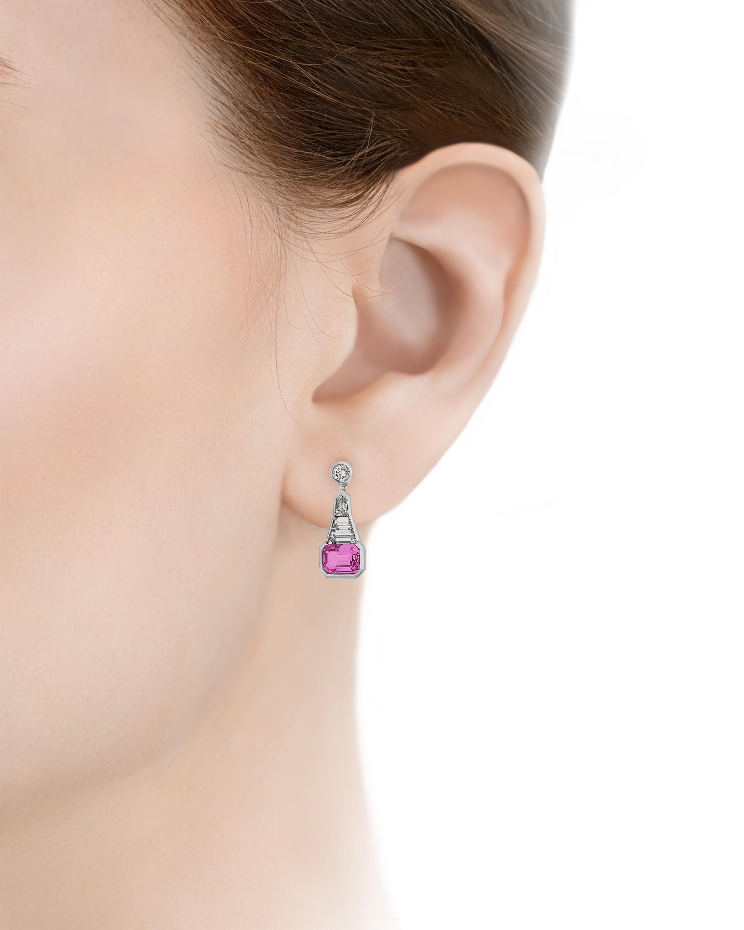Two eye-catching octagonal step-cut pink sapphires totaling 3.90 carats are set in these elegant drop earrings. The pair dangle from a glistening collection of white diamonds totaling 1.91 carats. Pink sapphires are among the world's most desirable