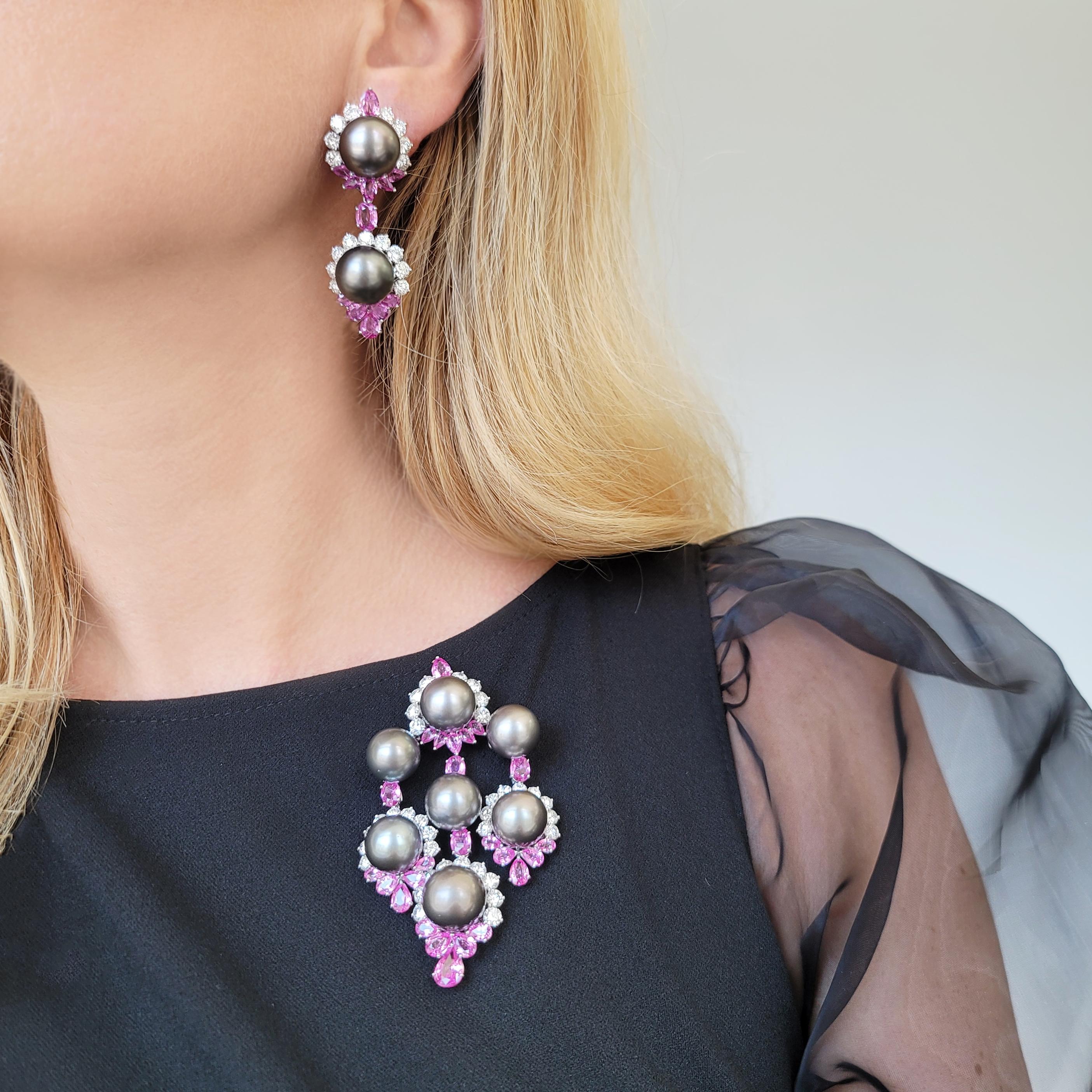 Pink Sapphire, Diamond, and Cultured Grey Pearl Pendant and Earrings. This pendant has 35 round brilliant diamonds with a total carat weight of approximately 8.75ct and 25 pink sapphires, oval and pear shape, with a total carat weight of