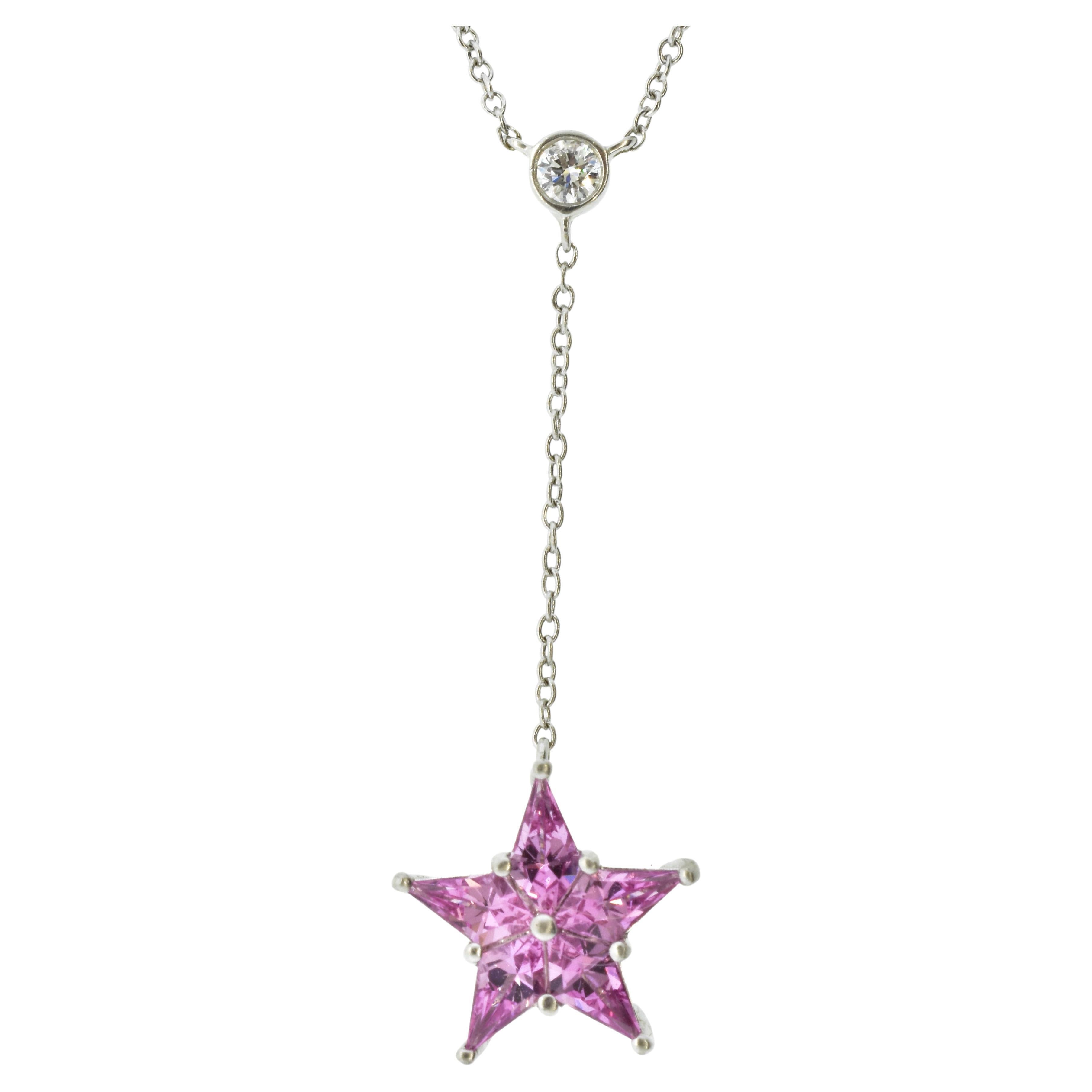 Tiffany 18K white gold necklace terminating with a pendant of pink sapphires set in a star motif.  The platinum  star pendant is suspended from a fine, collet set diamond, weighing approximately .10 cts., near colorless, (G) and very slightly