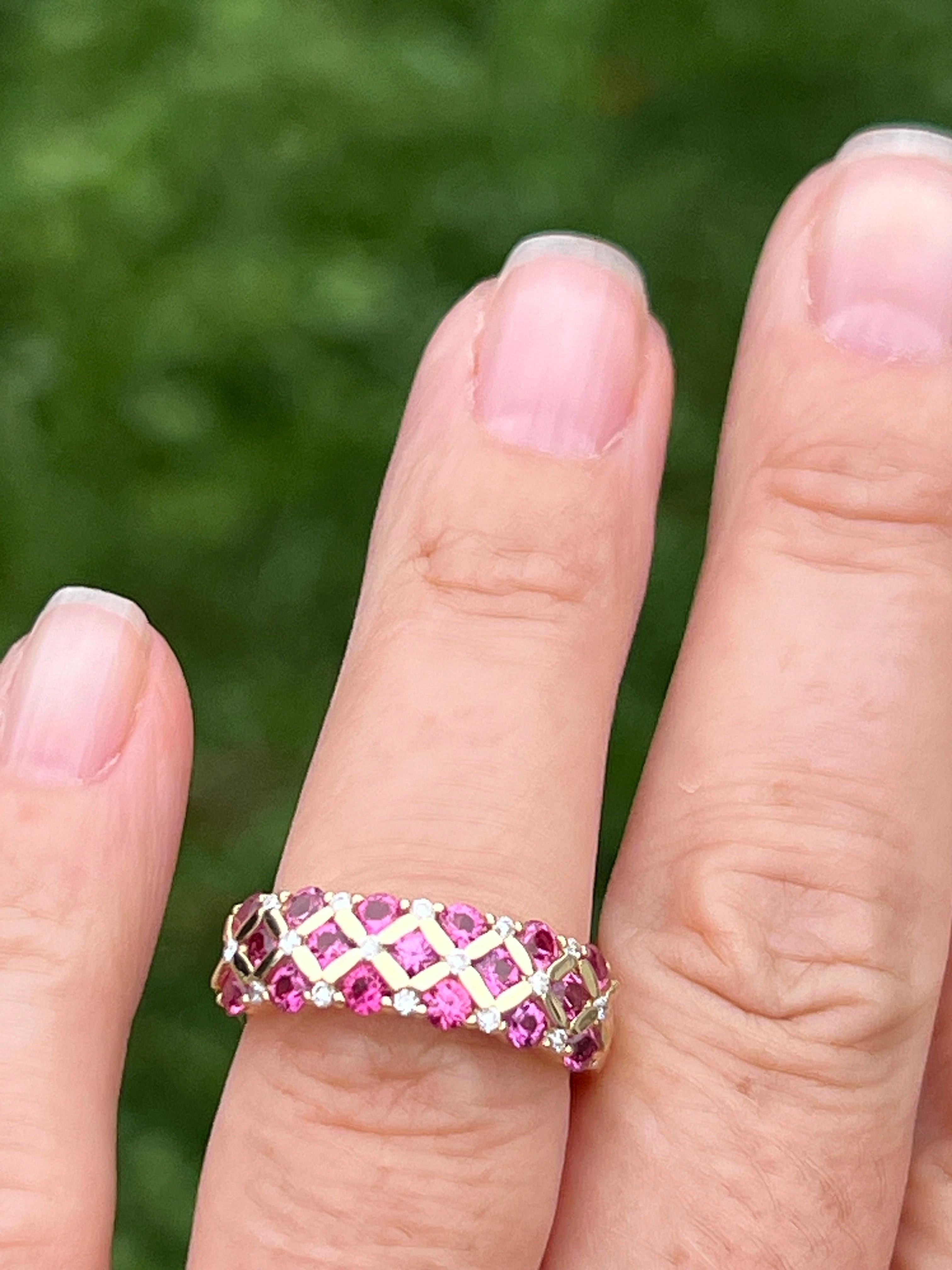This contemporary 14 karat yellow gold ring features a unique checkerboard design, set with seventeen round pink sapphires totaling approximately 1.36 carats. Complementing the sapphires are sixteen round brilliant diamonds, with a total weight of