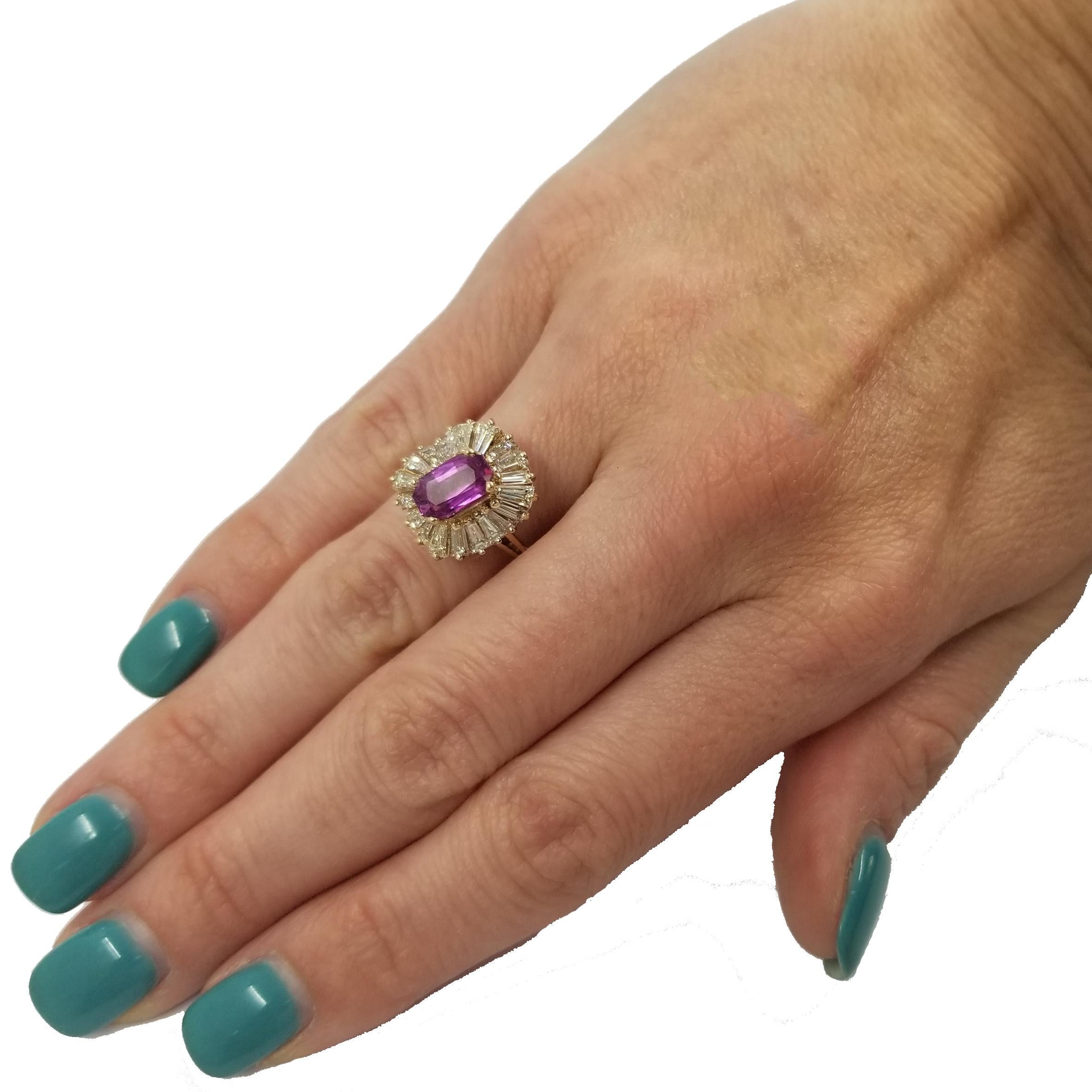 14 Karat Yellow Gold Ring With Approximately 1 Carat Elongated Oval Pink Sapphire. 20 Tapered Baguette Cut Diamonds of VS Clarity & H Color Totaling Approximately 1 Carat. Current Finger Size 7; Purchase Includes Free Sizing.