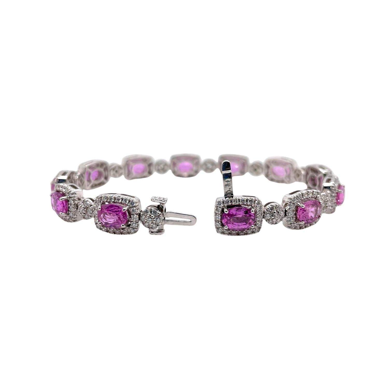 Bracelet contains 12 oval cut finely matched pink sapphires 10.74tcw and round brilliant diamond accents totaling 2.40tcw. Diamonds are near colorless and SI1 in clarity, excellent cut. All stones are mounted in a handmade prong setting. Bracelet