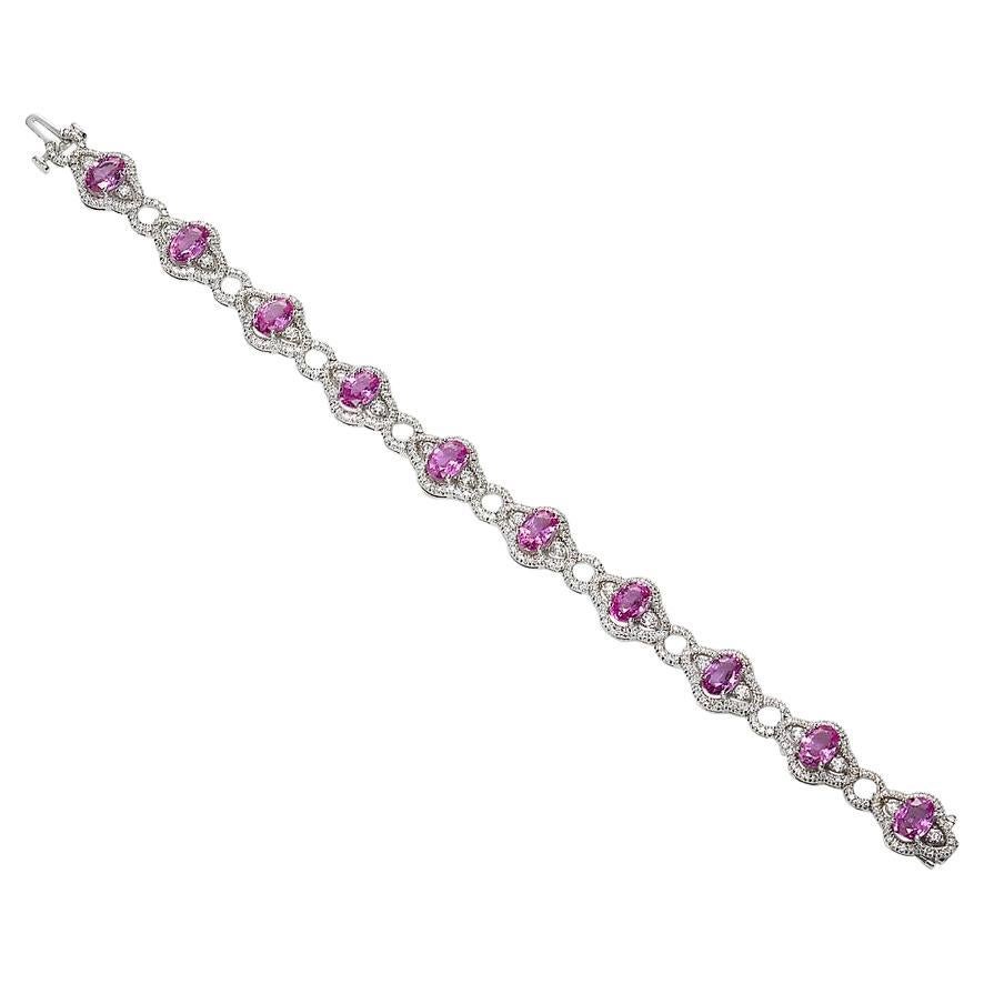 Bracelet contains 10 finely matched oval shape pink sapphires weighing a total of 9.00cts and 380 round brilliant diamond accents totaling 2.50cts. Diamonds are near colorless and SI1 in clarity, excellent cut. All stones are mounted in a handmade
