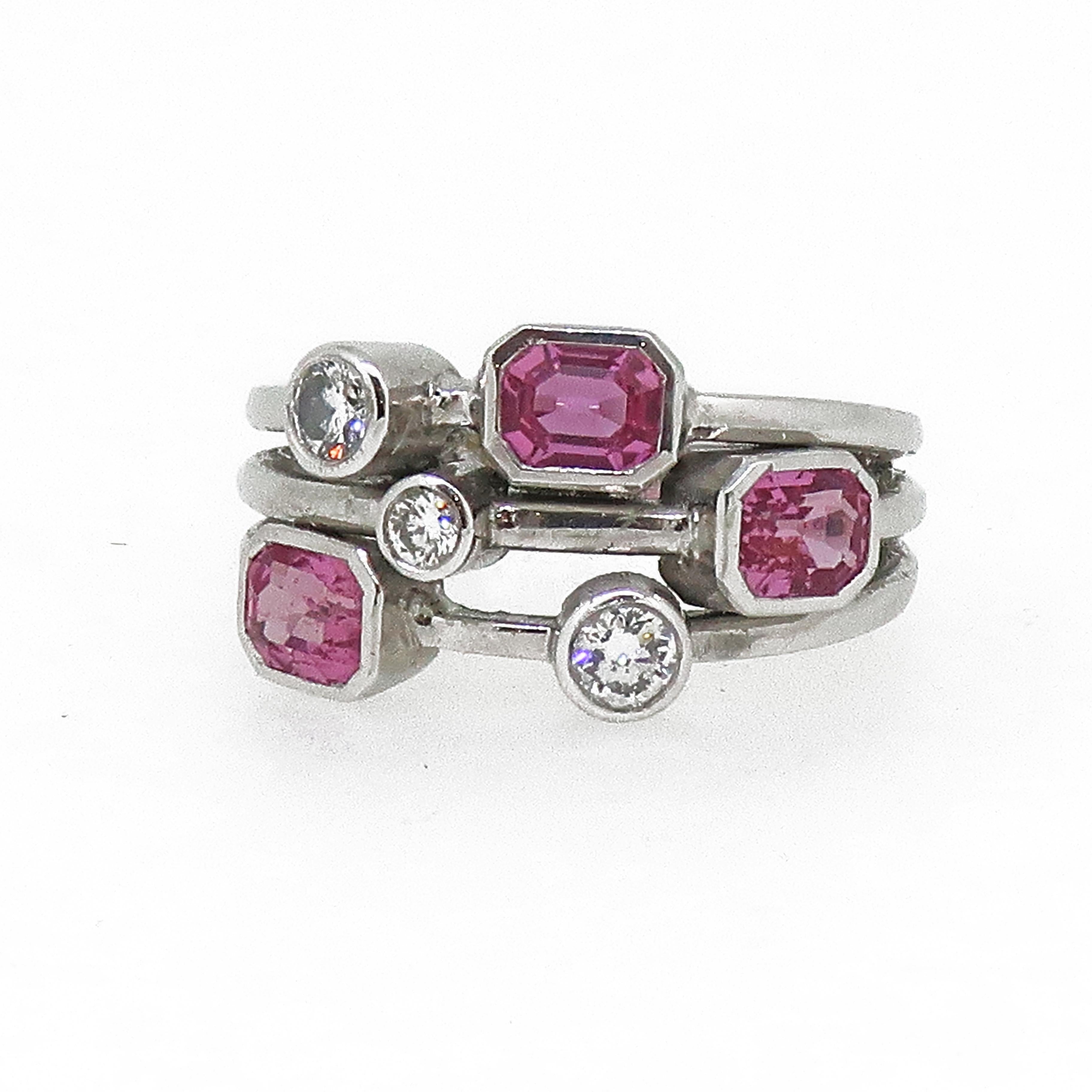 Pink Sapphire & Diamond Cluster Ring 18 Karat White Gold

A unique abstract pink sapphire and diamond cluster ring. Consisting of three emerald cut pink sapphires and three brilliant cut diamonds, all set in individual rub over settings spread out