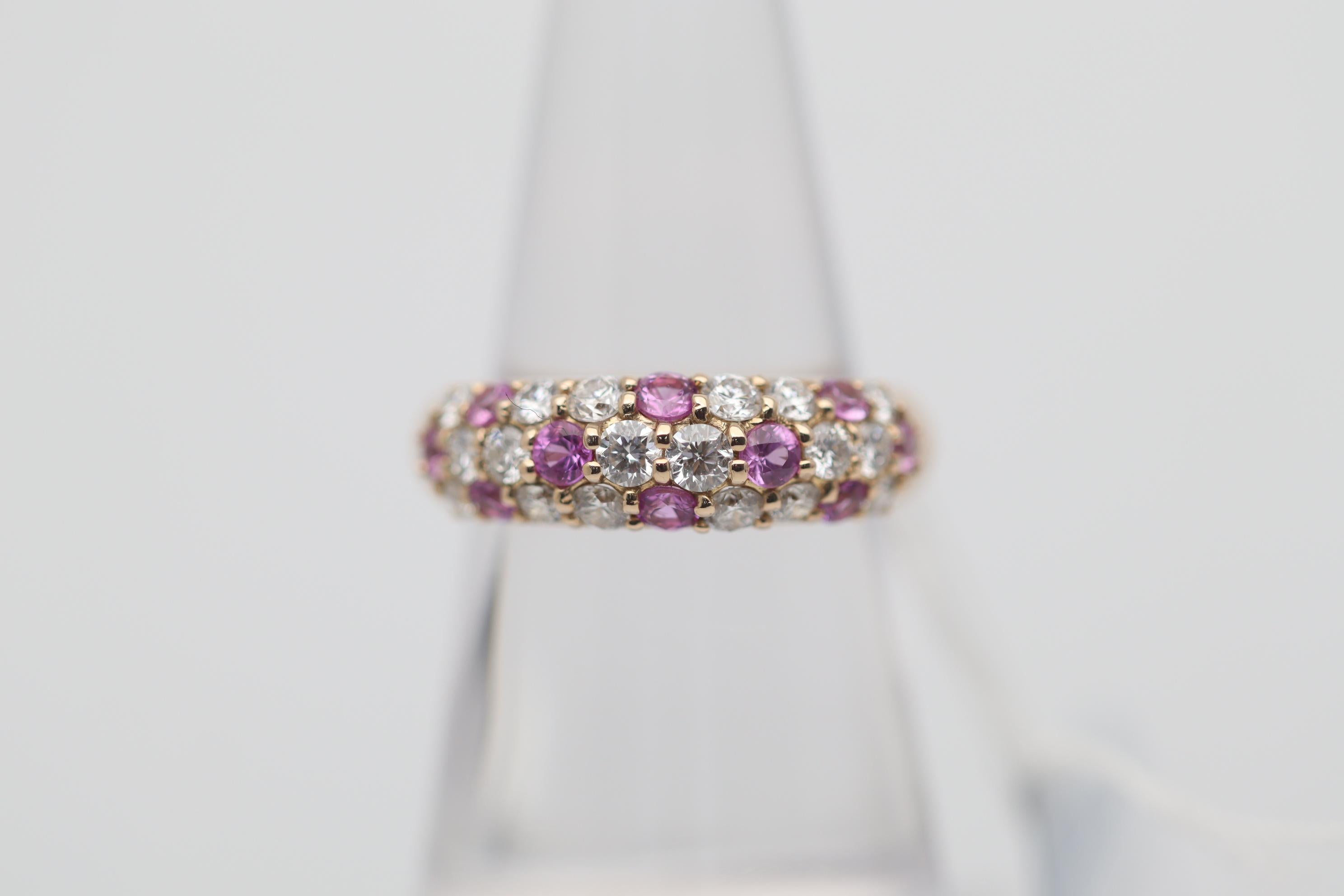 A simple yet stylish gold band featuring fine pink sapphires and diamonds! The diamonds weigh a total of 0.66 carats and blanket the top portion of the band. Poke-doting the diamonds are 10 pink sapphires weighing a total of 0.85 carats which add a
