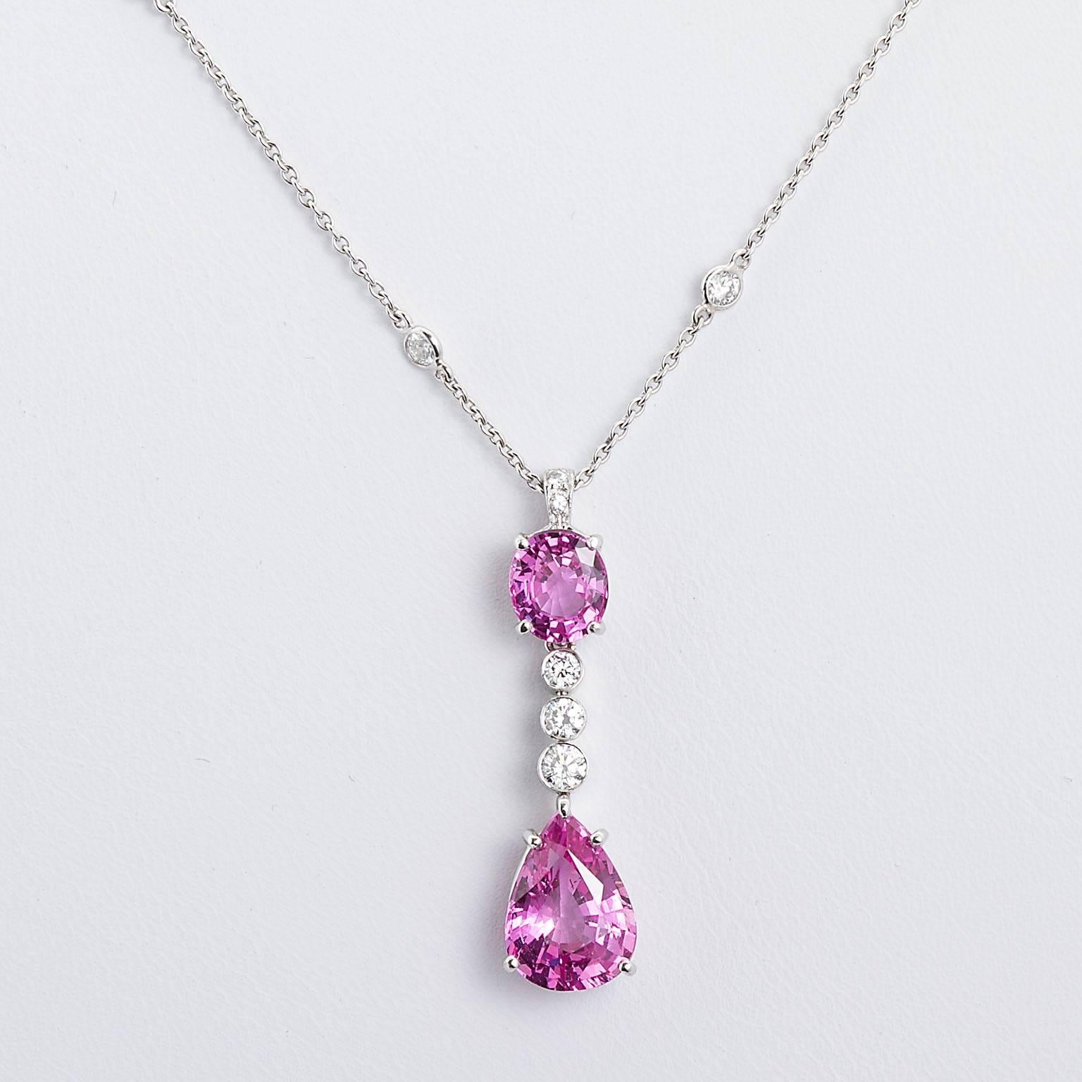 Belle en rose. A fine pink sapphire and diamond pendant in platinum with diamond by yard necklace. Set with a 3.66 ct. pear shape purplish pink sapphire, a 1.59 ct. purple pink sapphire, and 1.10 ctw of round brilliant diamonds.
Pendant is approx.