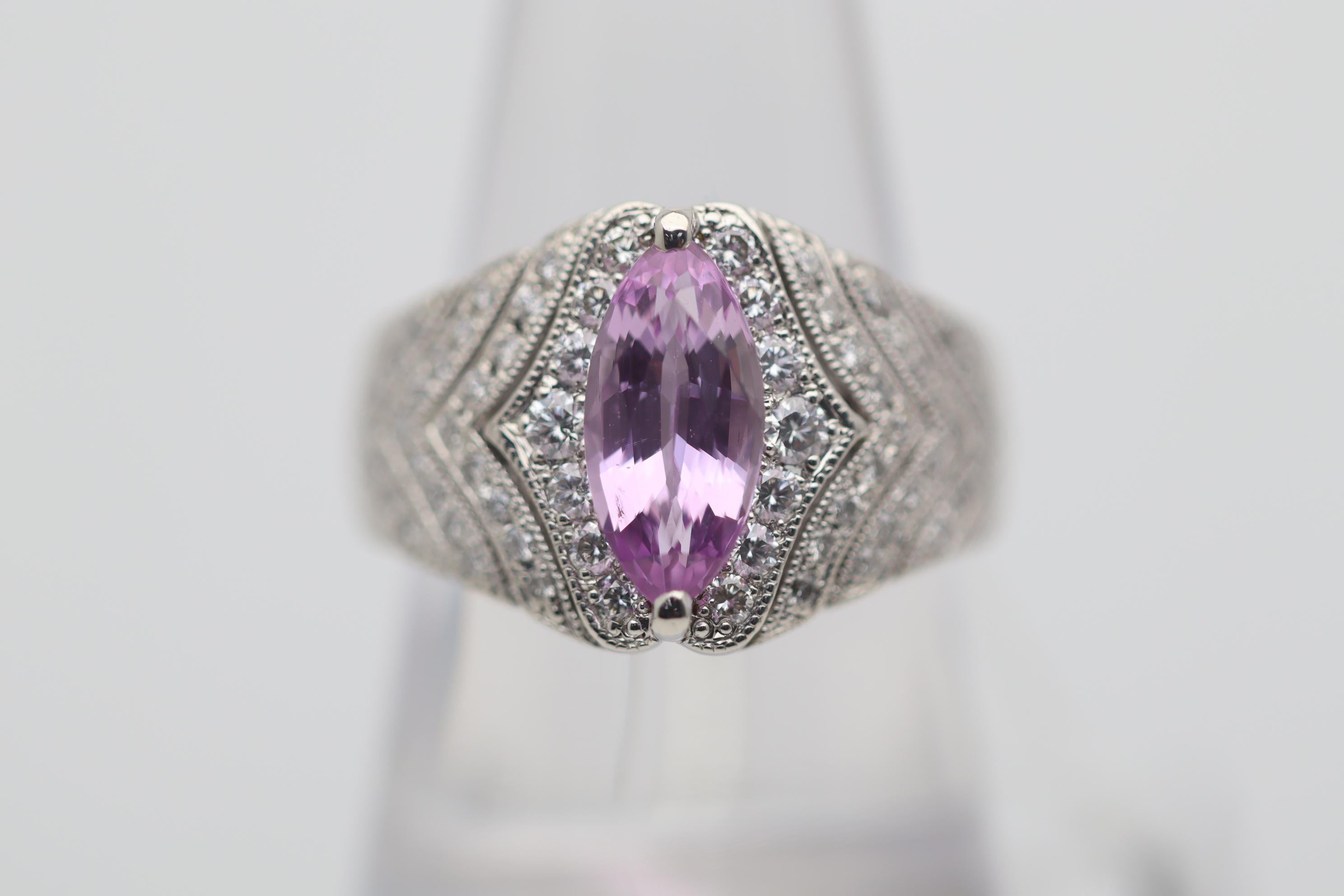 A lovely 2.40 carat pink sapphire takes center stage of this platinum made ring. It has a sweet pink color along with a beautiful long marquise-shape. It is complemented by 0.70 carats of round brilliant-cut diamonds set on its sides. Adding to
