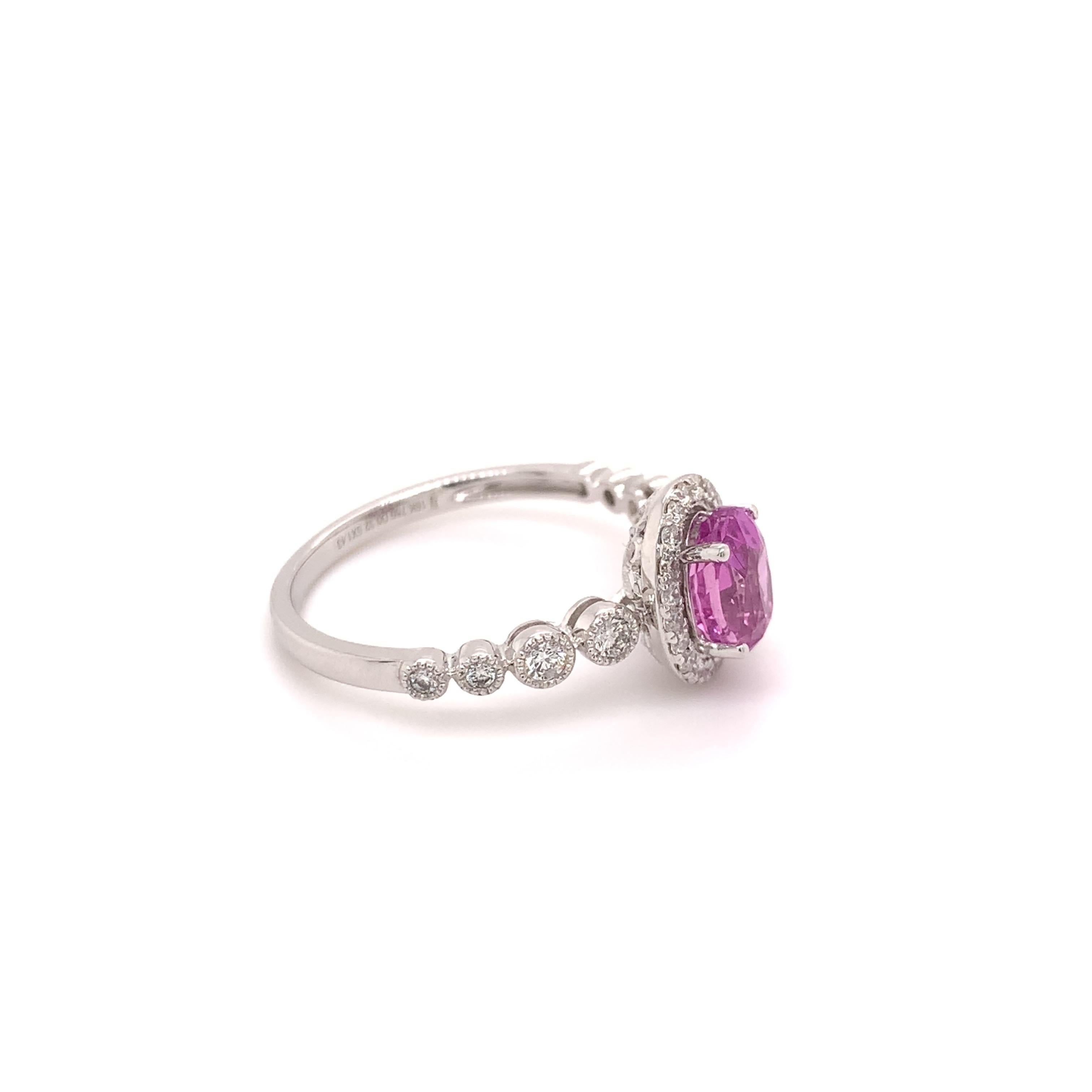 Elegant pink sapphire diamond ring. High brilliance, oval faceted, 1.43 carats natural pink sapphire mounted in high profile with four bead prongs, accented with round brilliant diamonds. Handcrafted design set in 18 karats high polished white gold.