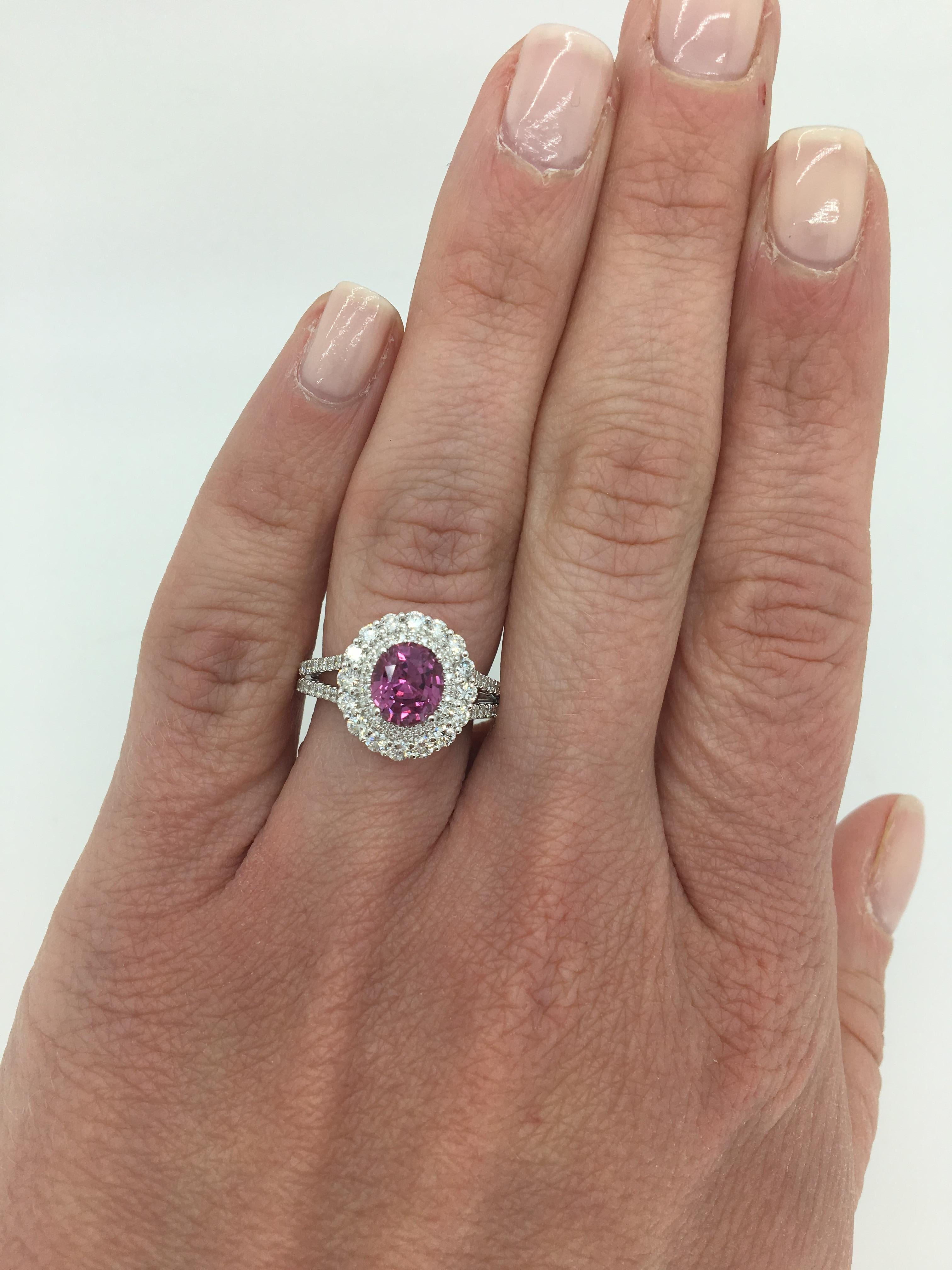 Approximately 1.51CT Pink Sapphire crafted in a 14k white gold split shank diamond halo cocktail ring.

Gemstone: Approximately 1.51CT Oval Cut Pink Sapphire 
Diamond Carat Weight: Approximately .80CTW
Diamond Cut: Round Brilliant 
Diamond Color:
