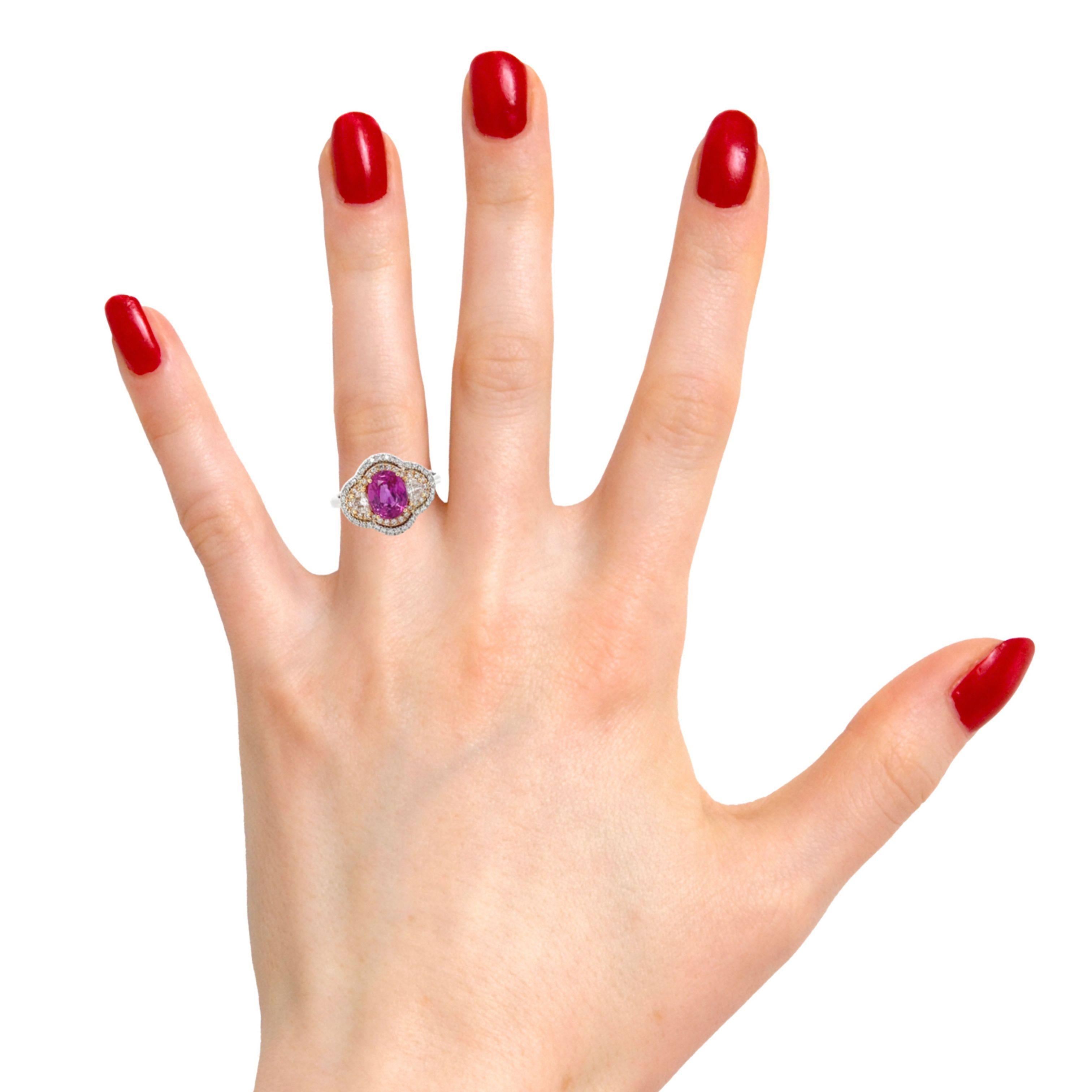 Ring contains 1 center oval brilliant pink sapphire 2.01ct, two matching half moon diamonds 0.25tcw and round brilliant diamonds within double halo 0.35tcw. Diamonds are G in color and VS1 in clarity, excellent cut. All stones are mounted in 18k