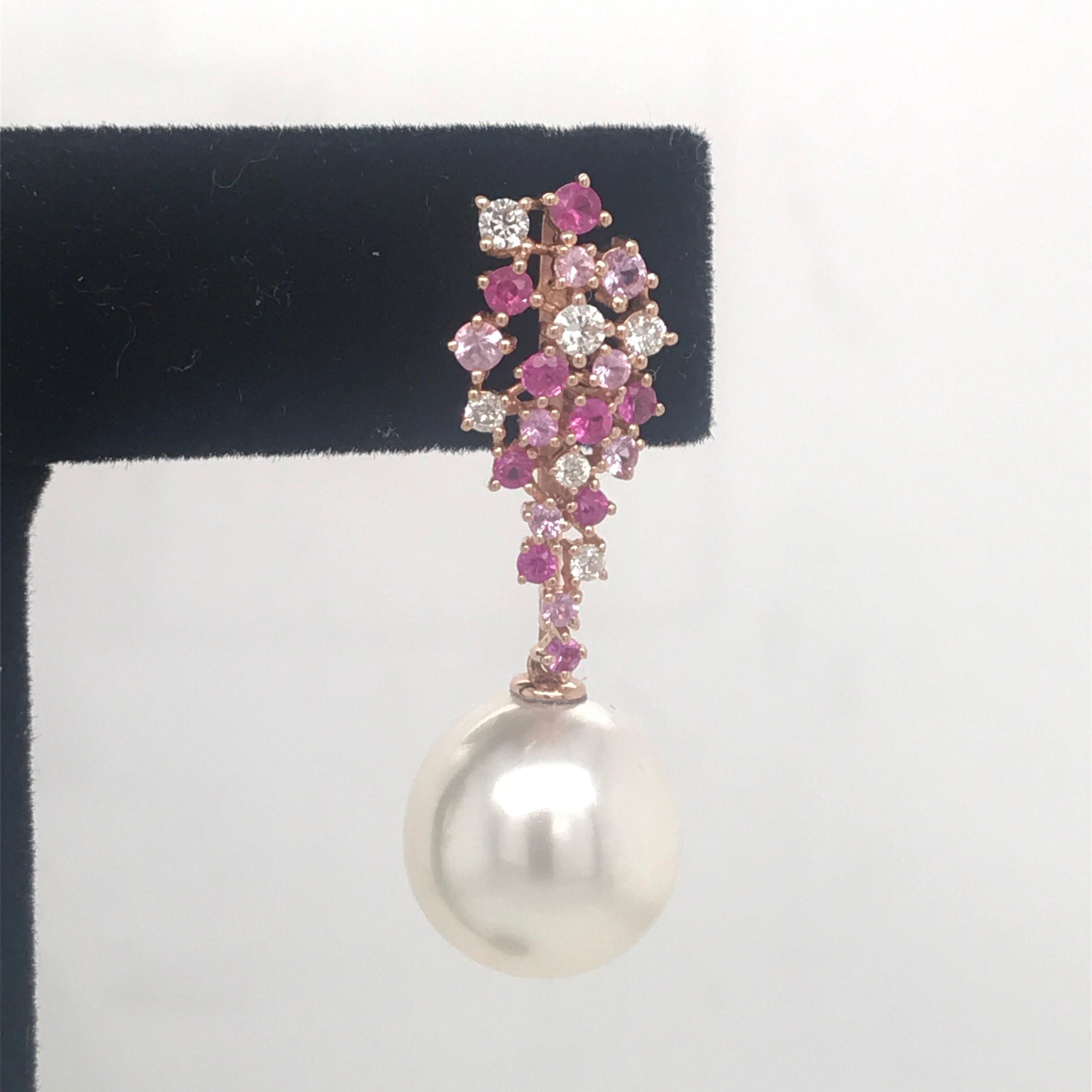 18K rose gold drop earrings featuring a cluster of 34 pink sapphires weighing 1.07 carats and 12 diamonds weighing 0.34 carats with two South Sea Pearls measuring 12-13 mm.