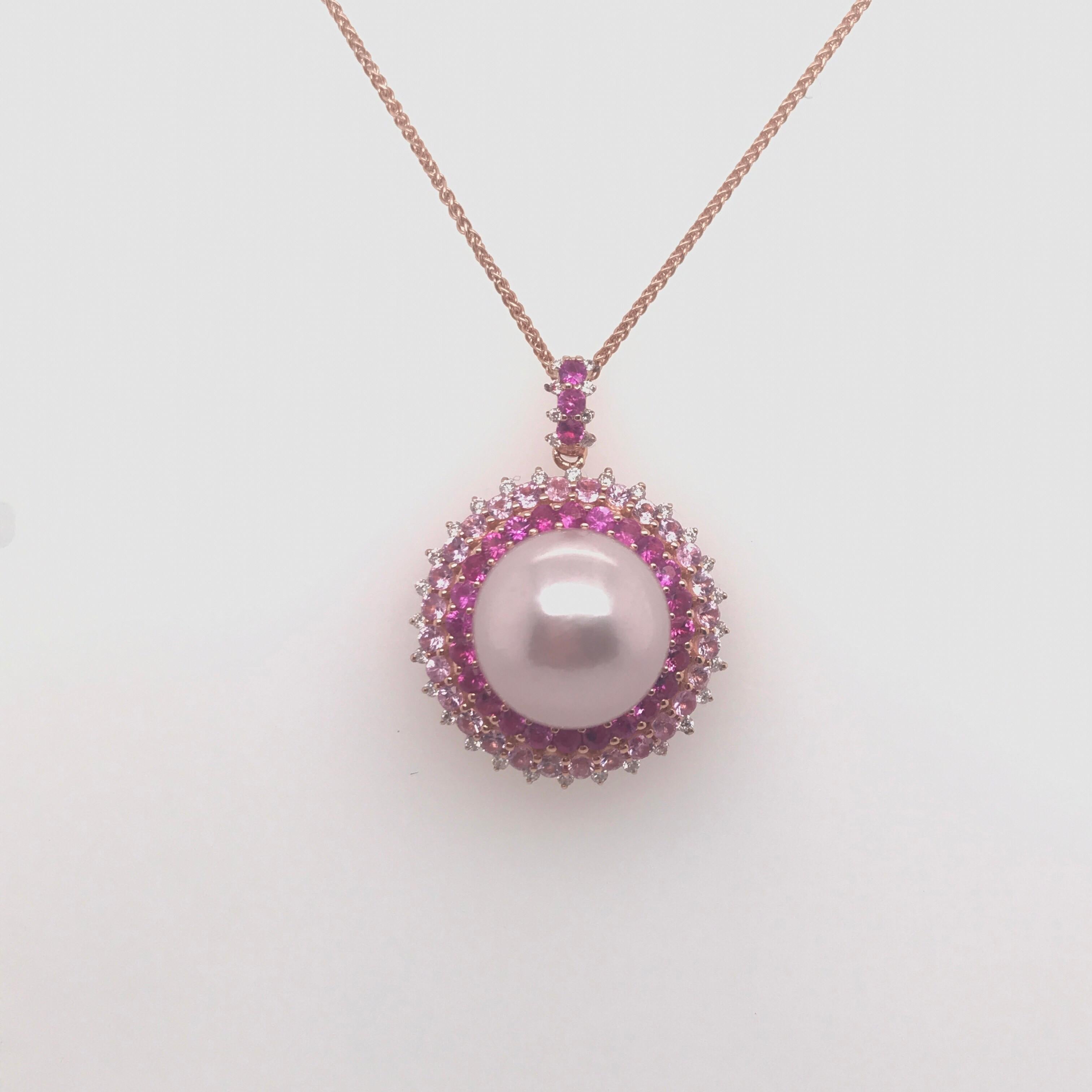 18K Rose Gold pendant necklace featuring one Pink Freshwater pearl measuring 13-14 mm flanked with pink sapphires weighing 1.97 carats and 36 round brilliants weighing 0.22 carats. 