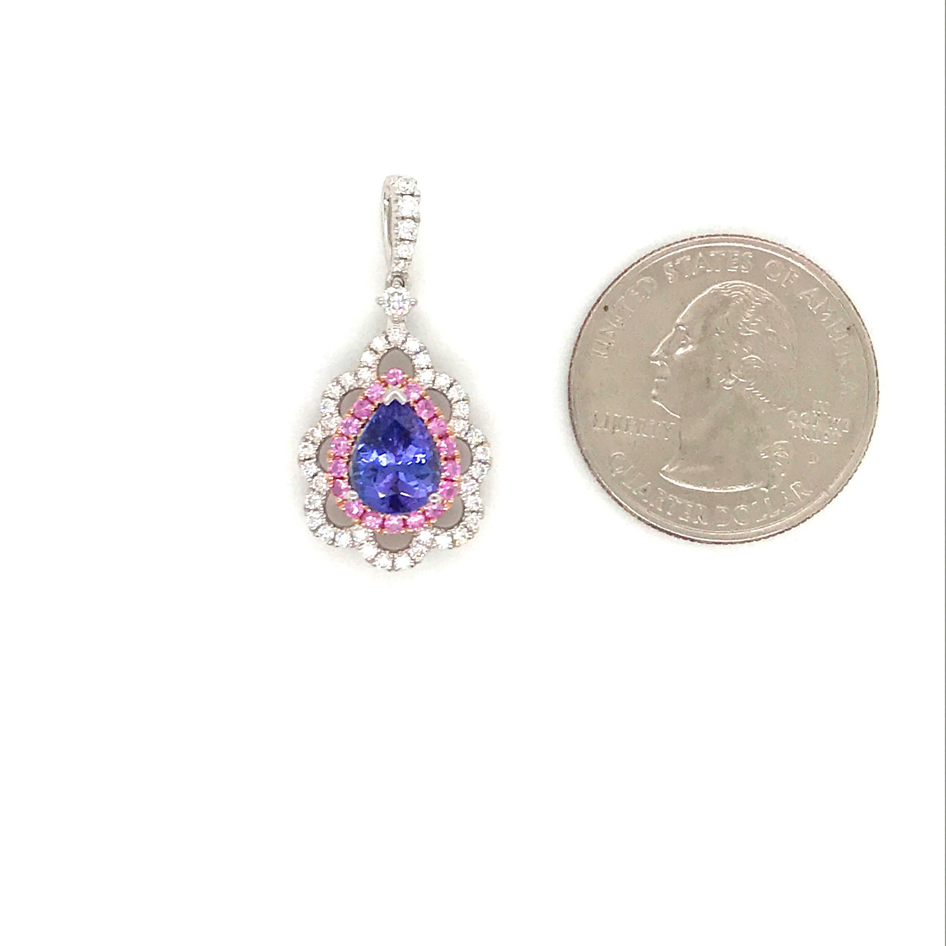 18K White gold pendant featuring one pear shape tanzanite weighing 1.88 carats flanked with pink sapphires, 0.30 carats and round brilliance 0.43 carats. Comes with 14k white gold chain. 
Color G
Clarity SI