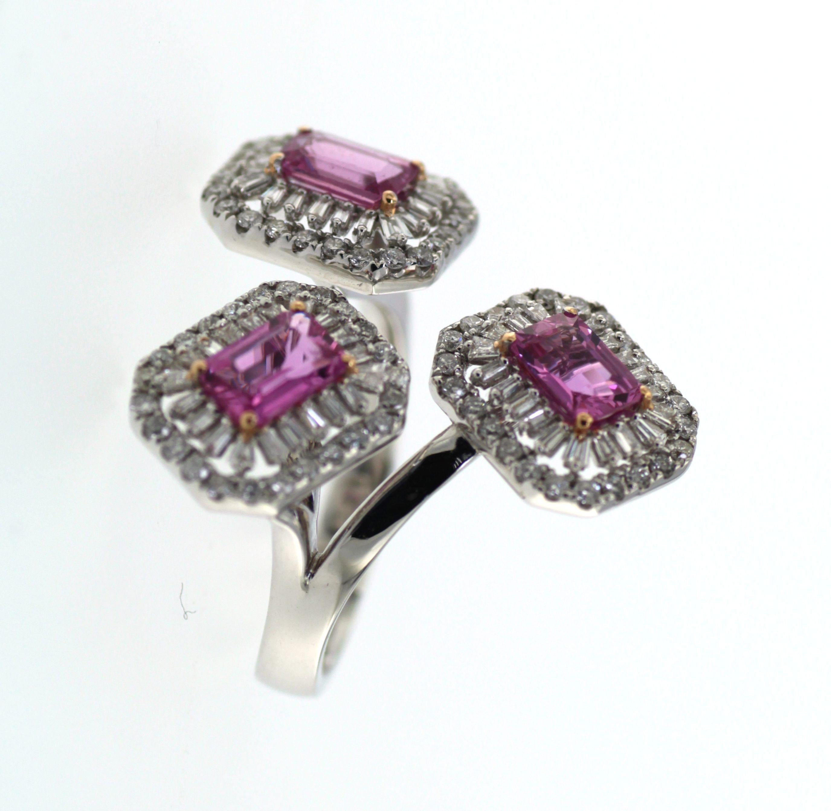 Elegance meets timeless sophistication in this remarkable ring, which harmoniously blends the allure of rare gemstones with the resplendence of precious metal. Anchoring the design are three captivating Pink Sapphires, cumulatively weighing 1.84