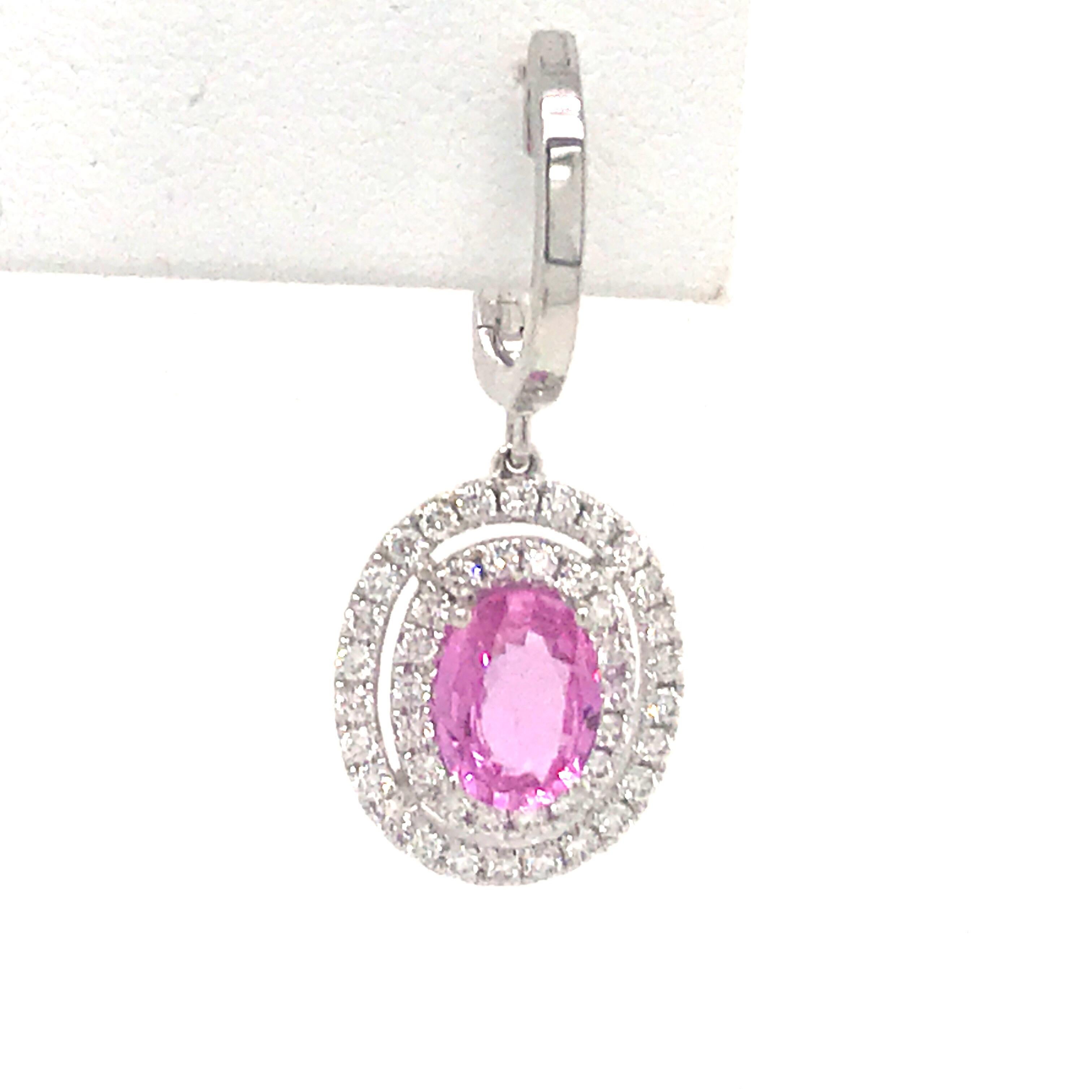 14K White gold drop earrings featuring two oval cut pink sapphires weighing 2.00 carats, flanked with a double diamond halo weighing 0.62 carats.
Color G
Clarity VS-SI