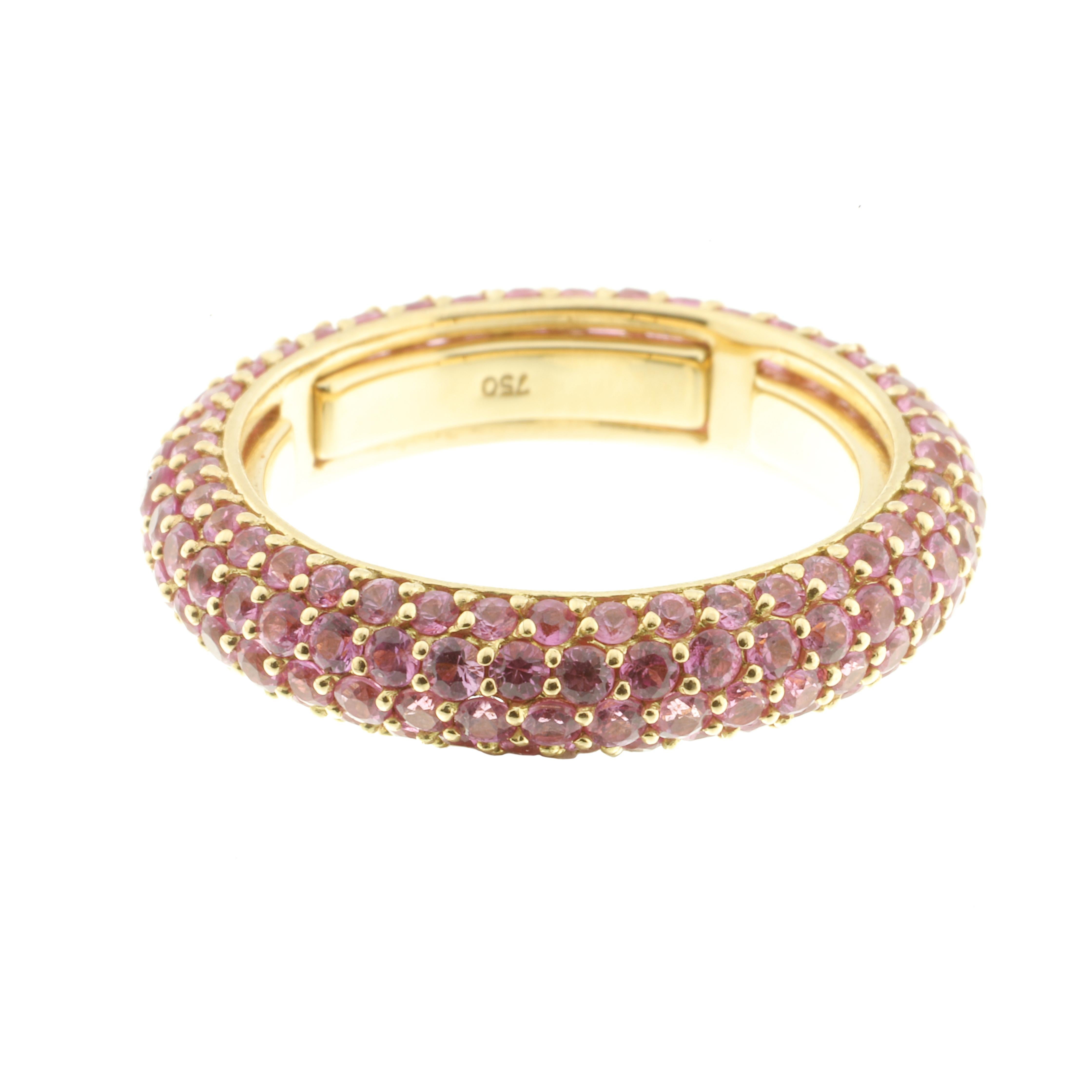 An 18-karat yellow gold ring encircled by 3.27 carats of pink sapphires.

The ring is fabulous to wear, inside the band are a series of sprung sizers which comfortably fit the ring to your finger. The piece stands out as a unique ring when worn