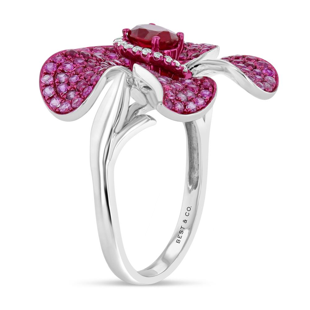 Vibrant pink sapphires and exquisite craftsmanship make this special flower ring a true work of art. The ring measures approximately 1 inch in diameter.  

(Approx. .7 carats of pink sapphires, a 1.3 carat ruby, and .08 carats of diamonds)