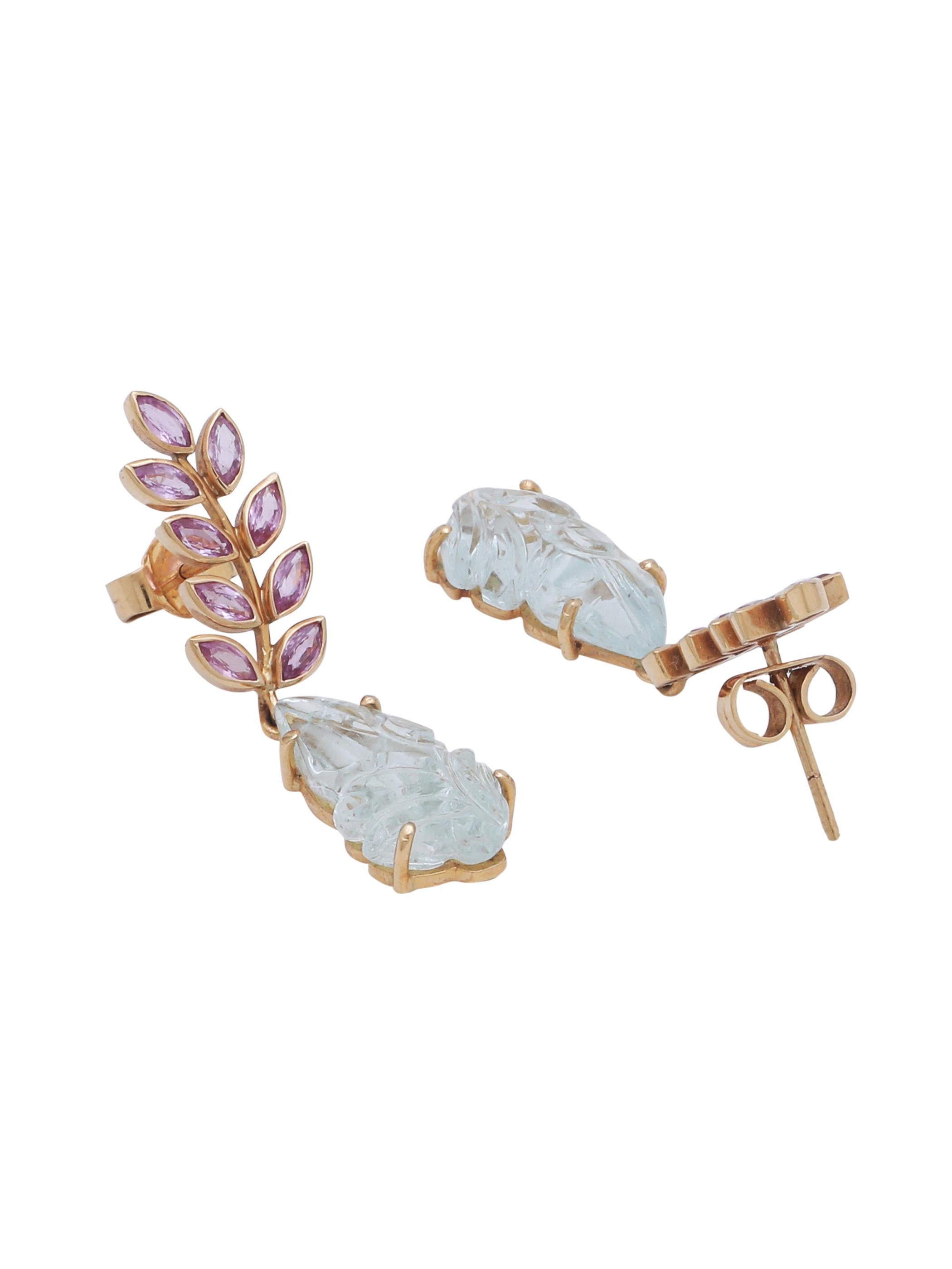 A simple yet chic earring pair with Pink Sapphire Marquise shape cut stones on the top and a pair of Hancarved Aquamarine leaf Hanging. The earring represents the leafs on the stem of a flower and the whole theme around it. The earrings is