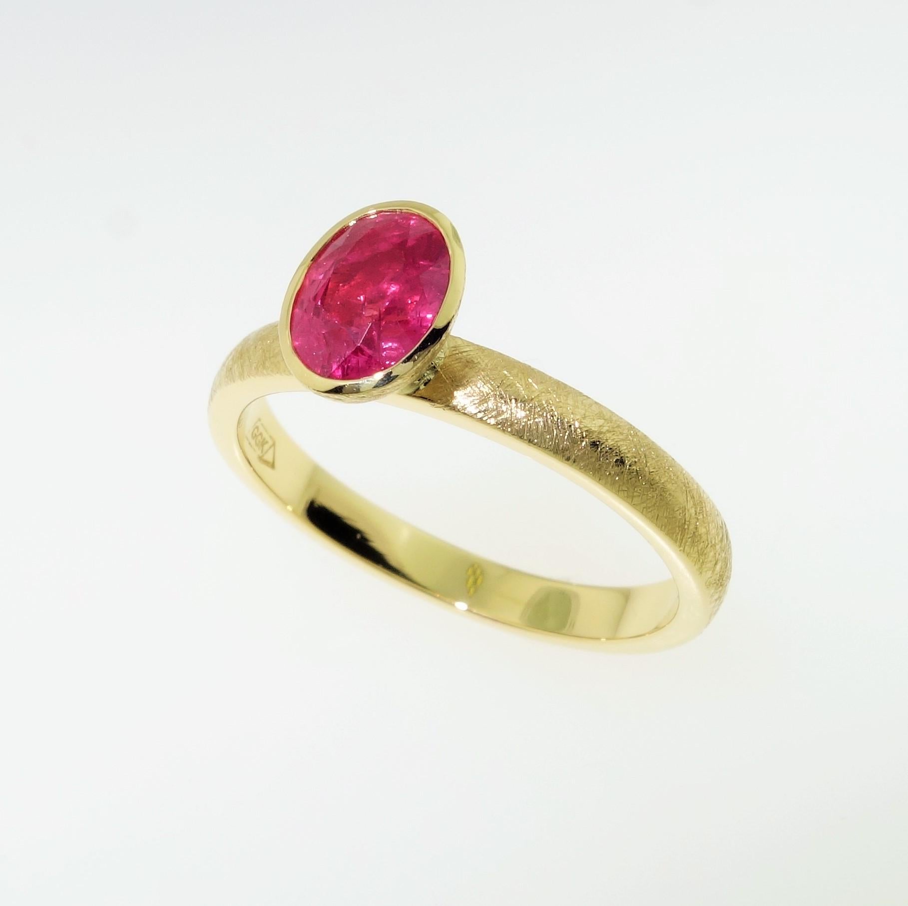 Simply Beautiful, Elegant and finely detailed Stacking Ring, set with an oval Pink Sapphire, weighing approx. 1.14 Carats and measuring 7mm x 5.2mm. Hand crafted and Hand Textured in 18 Karat Yellow Gold. The ring epitomizes vintage charm, taking