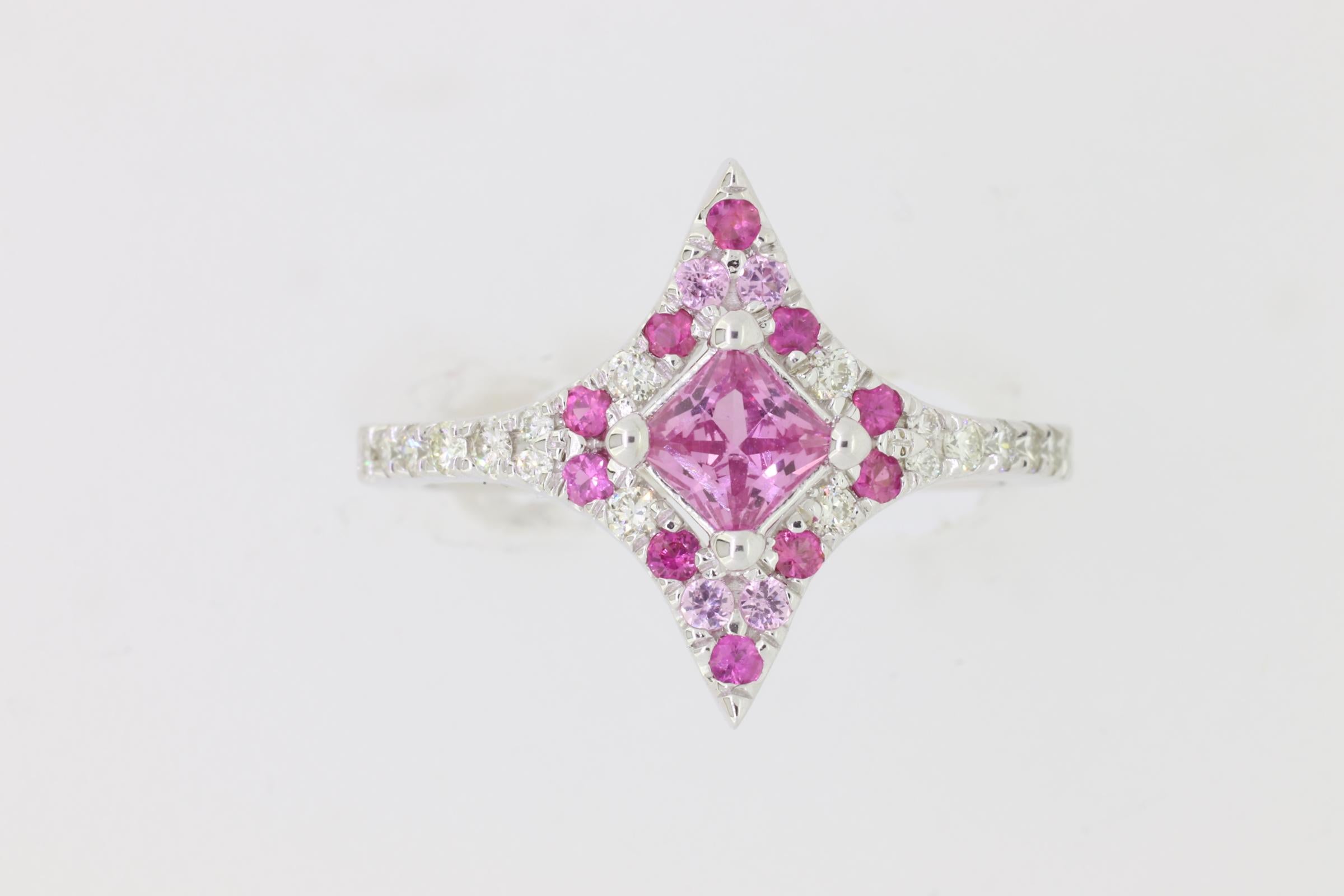 Material: 14k White Gold 
Center Stone Details: 1 Princess Cut Pink Sapphire at 0.75 Carats- Measuring 4.5 mm
Mounting Stone Details: 17 Multicolor Sapphires at 0.38 Carats
Diamond Details: 15 Round White Diamonds at 0.26 Carats - Clarity: SI /