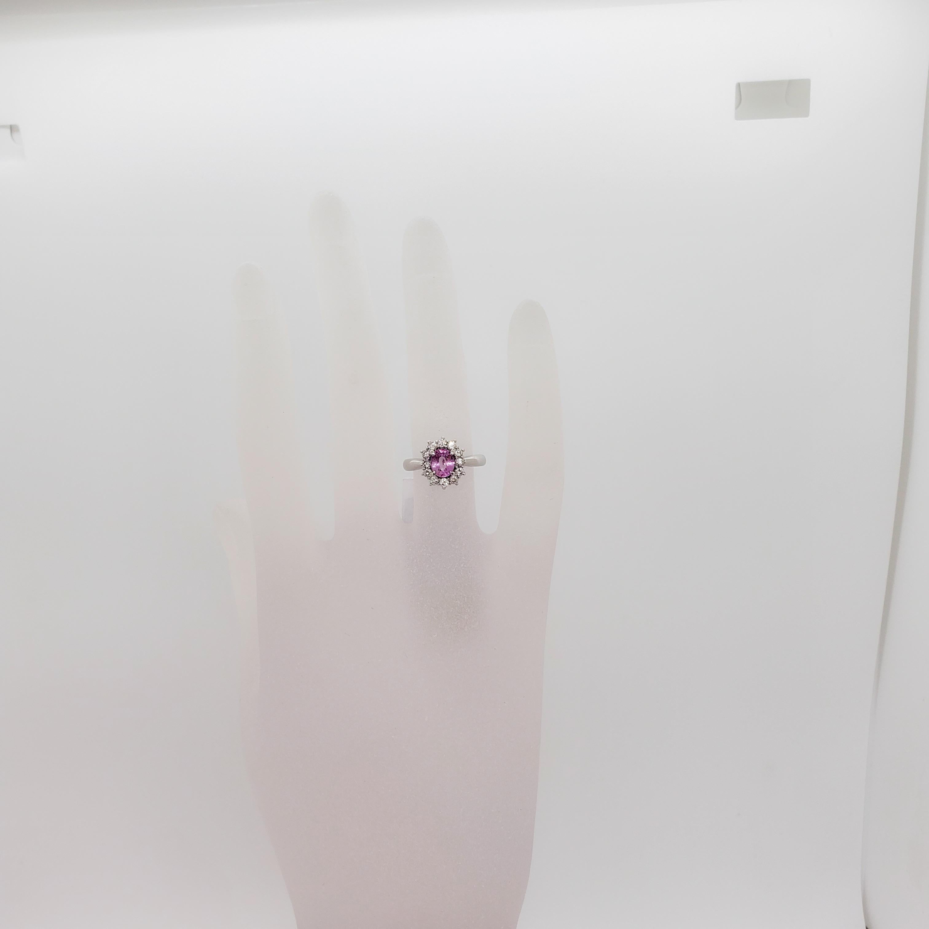 Beautiful bright pink color pink sapphire oval weighing 0.76 ct. with 0.30 ct. white diamond rounds.  Handmade platinum mounting in ring size 5.5.  