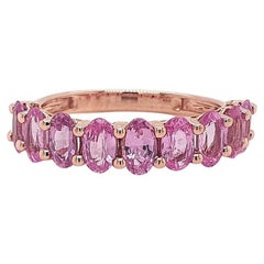 Zaffiro rosa ovale, fascia a mezza eternità in oro 14K