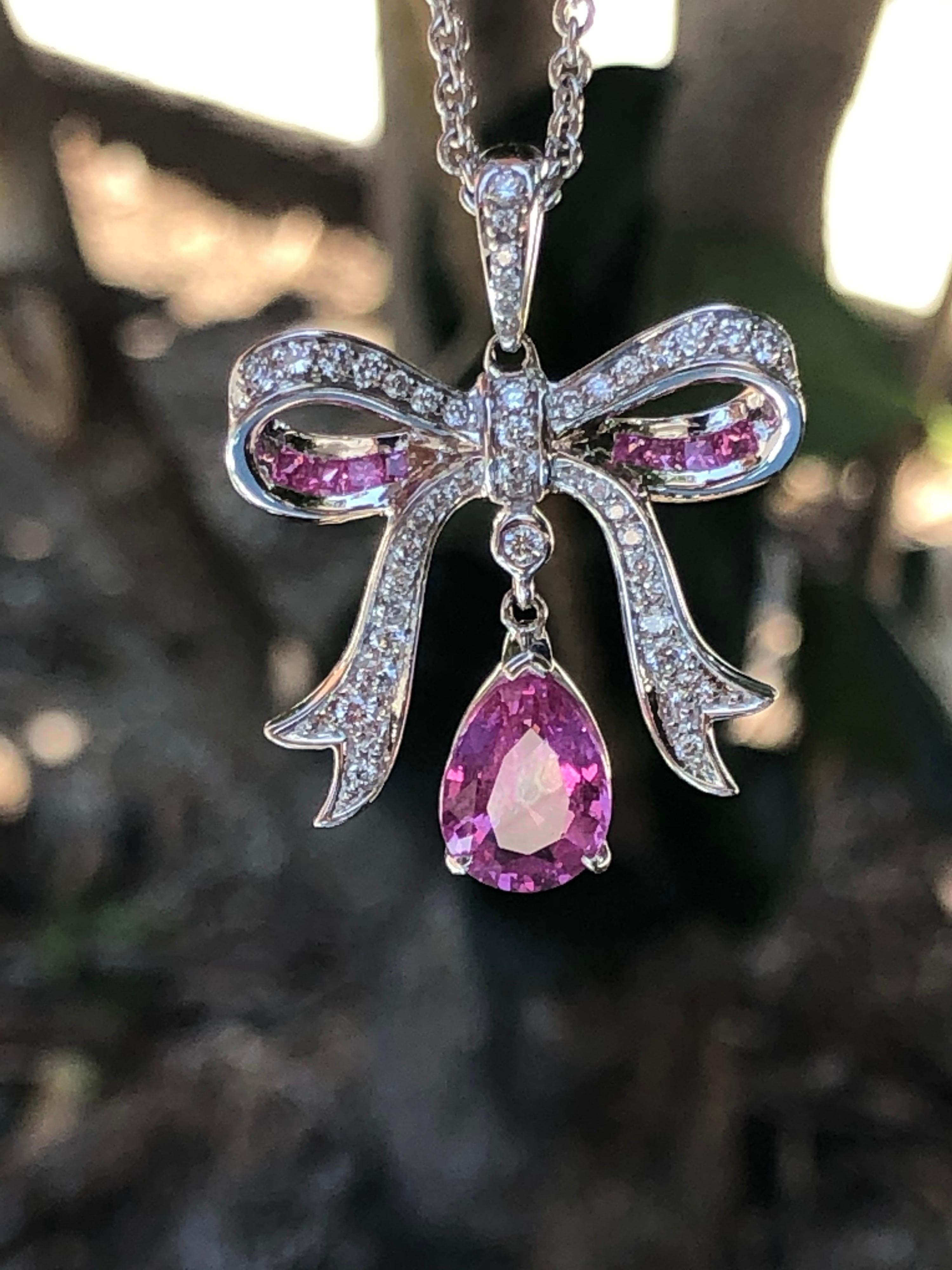 1.94 carat pear shaped Pink Sapphire is set in this 18K white gold pendant, adorned by 0.58 carats of square pink sapphires, and a total of 0.25 carats of round diamonds.
The chain length is 18