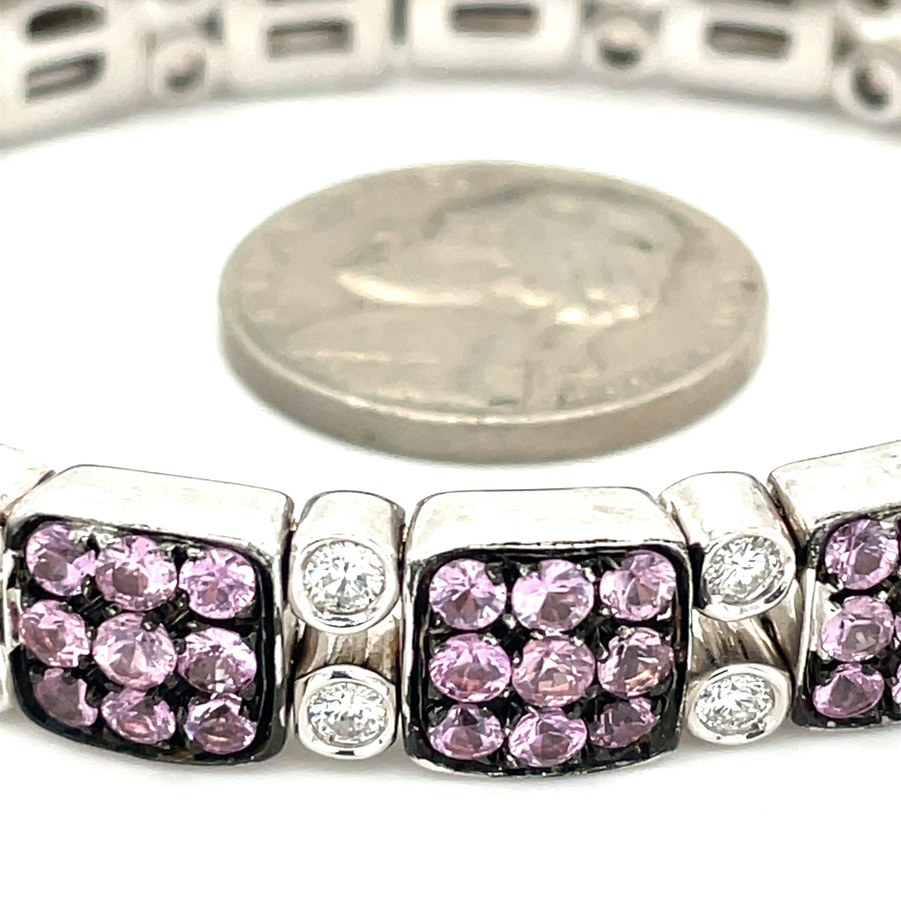 This gorgeous pink sapphire, pink zircon, and diamond bangle is the perfect addition to any jewelry collection. This elegant bracelet contains 5 carats of sparkling pink sapphire and pink zircon stones combined. In between the pink stones are .70