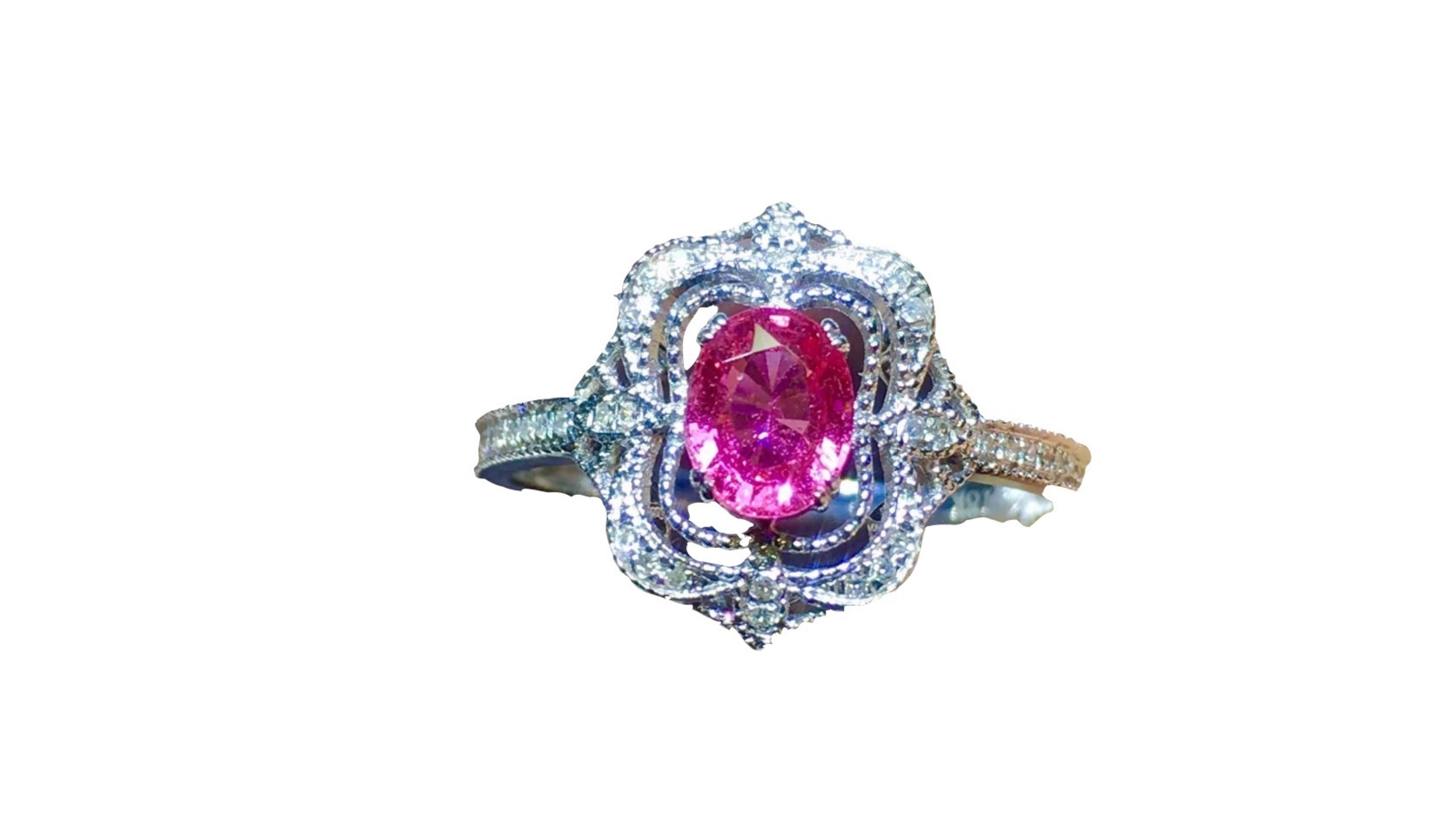 
0.62 Carat Pink Sapphire Ring 18 Karat White Gold with over 22  White diamonds and ones on each side of the band. This is a lot of detail as you can see around the main stone.

 Pink sapphires have been exponentially increasing in popularity as a