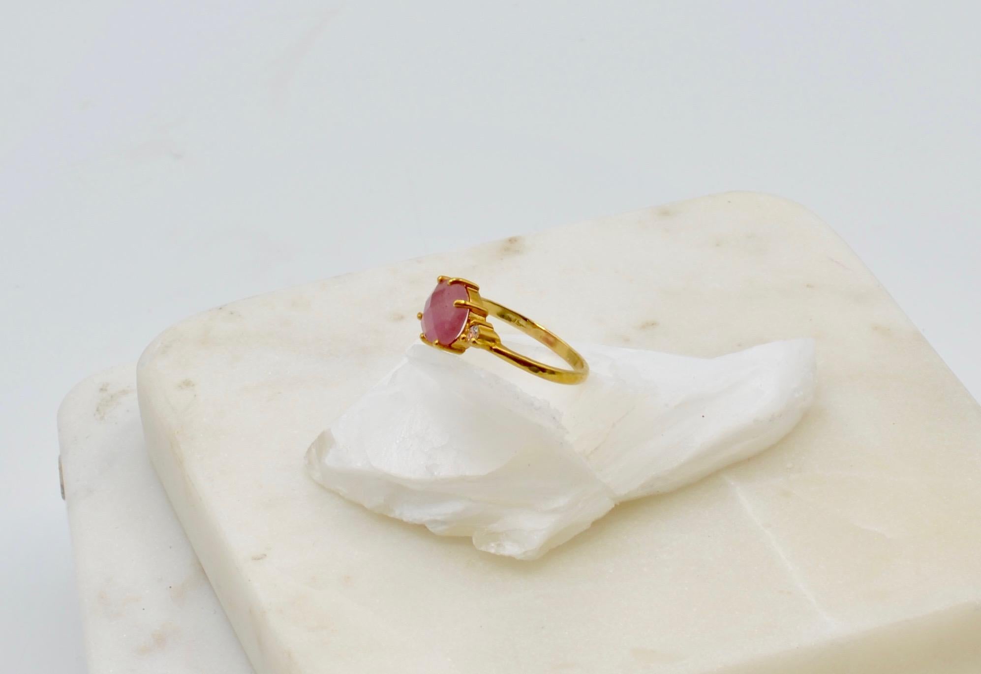 This beautiful pink sapphire is rose cut and measures aprox. 2.6 carats with two very bright white accent diamonds set in 14 karat gold.  It is an alternative engagement ring or your favorite every day ring. The ring is a size 6 3/4 and can be sized